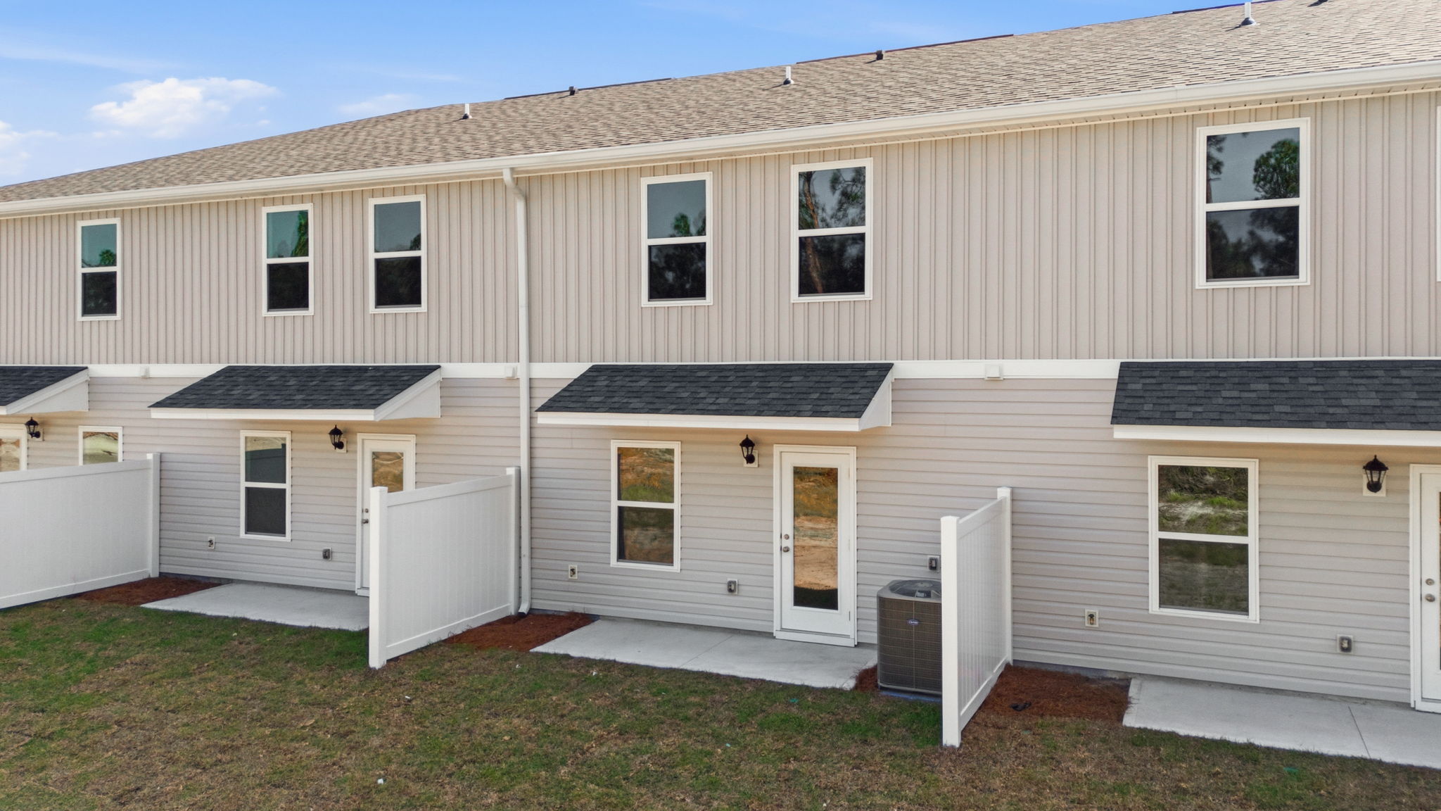 Covered back porch with air-conditioning unit.