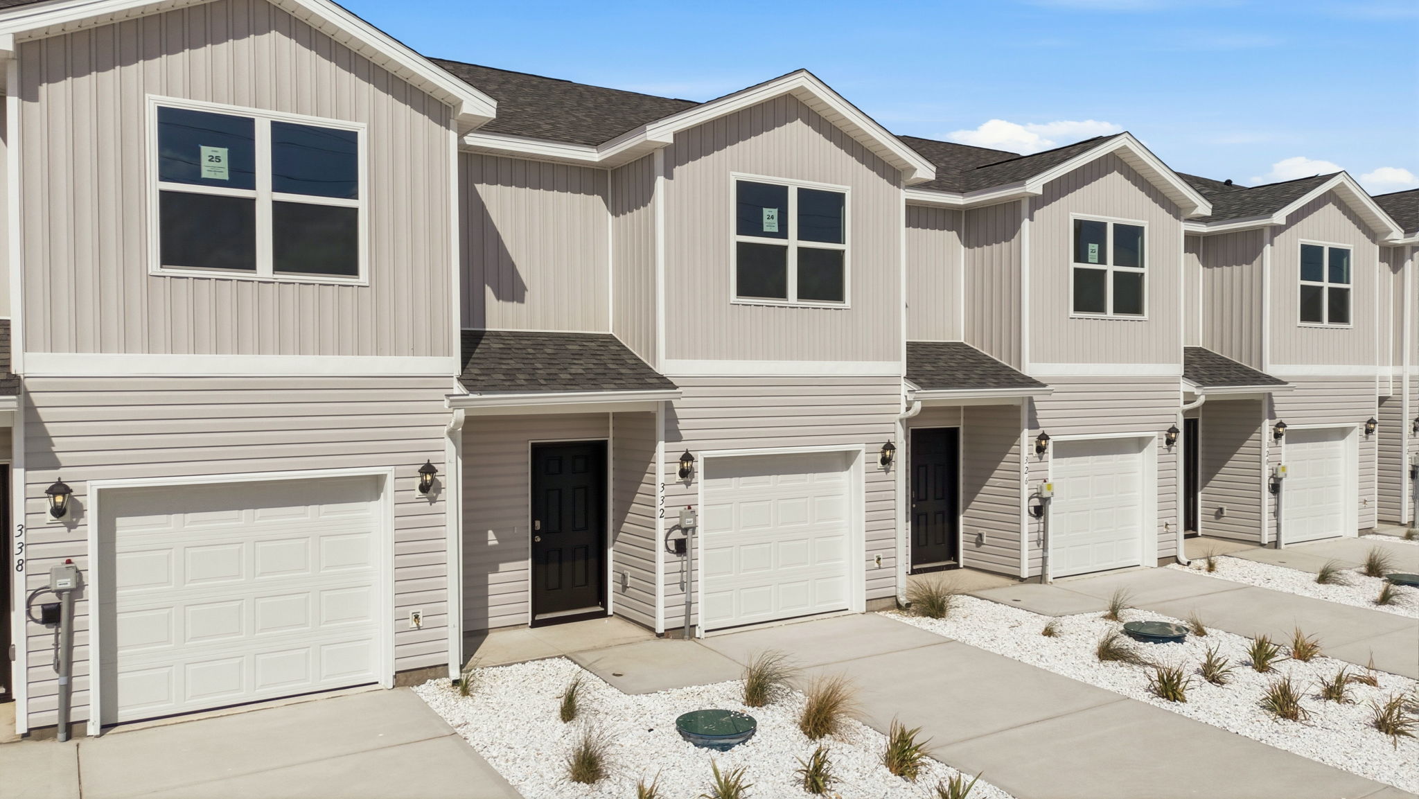 Sabal townhome with single car garage and vinyl siding.