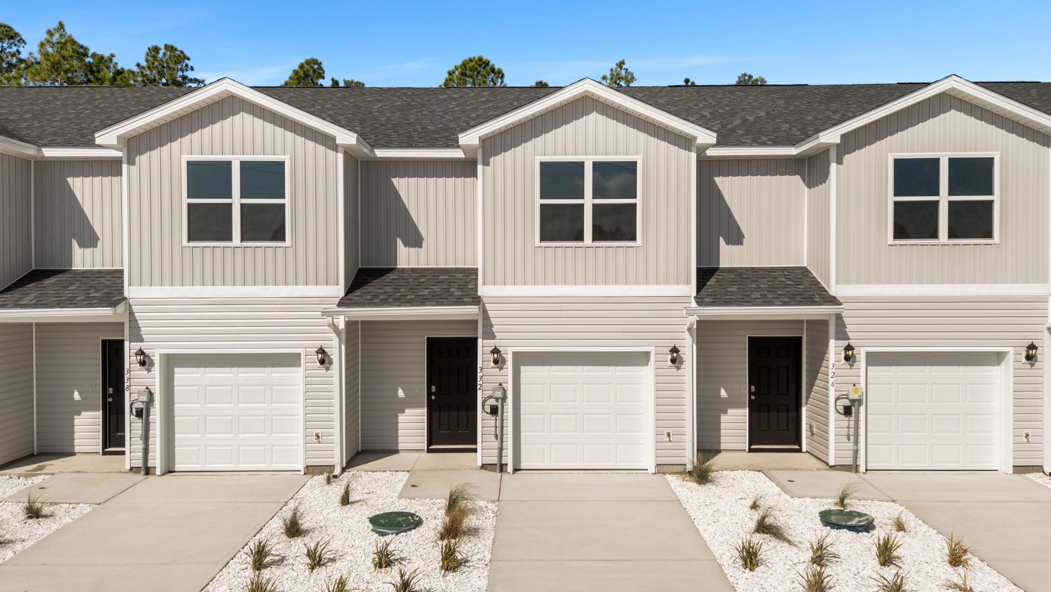 Sabal townhome with single car garage and vinyl siding.