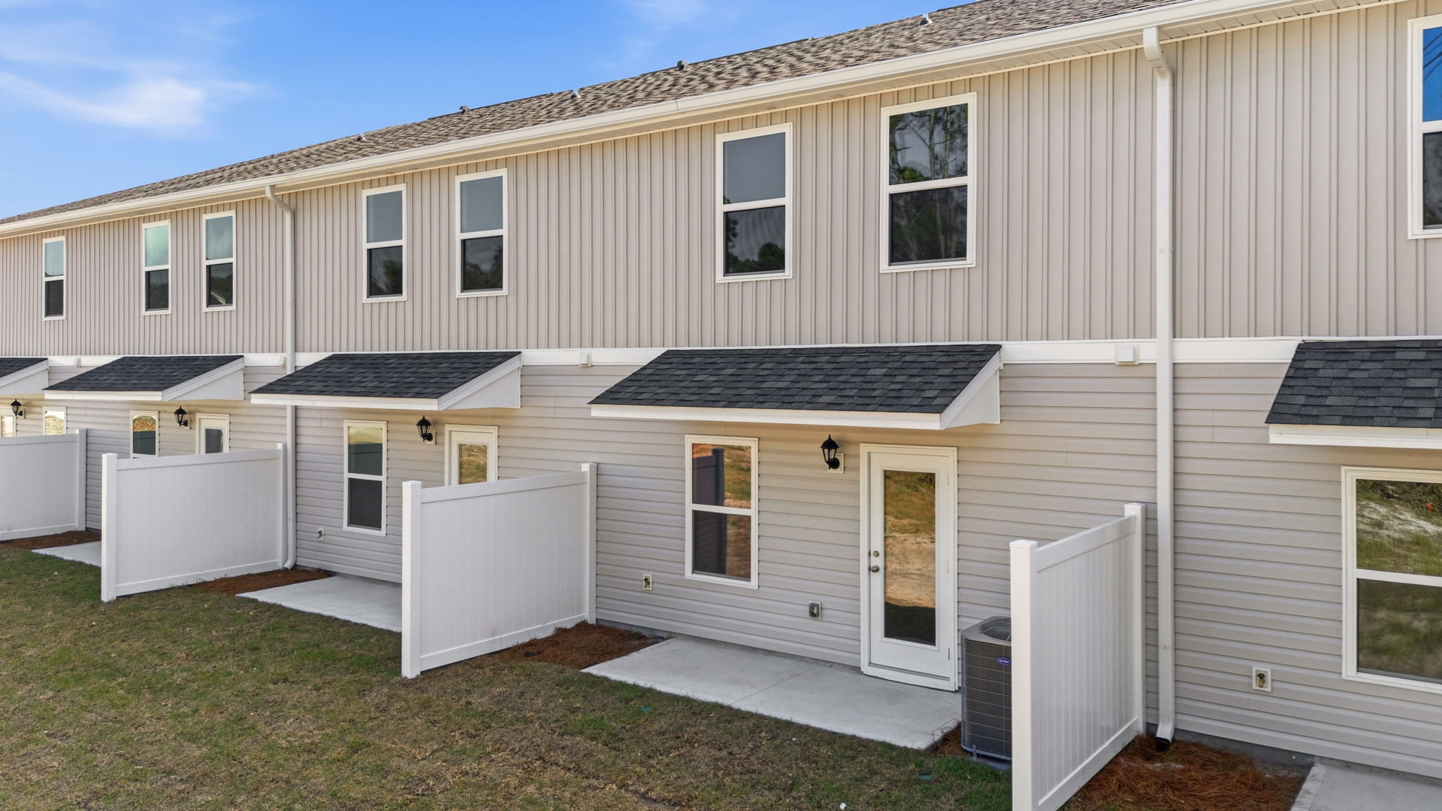 Covered back porch with air-conditioning unit.