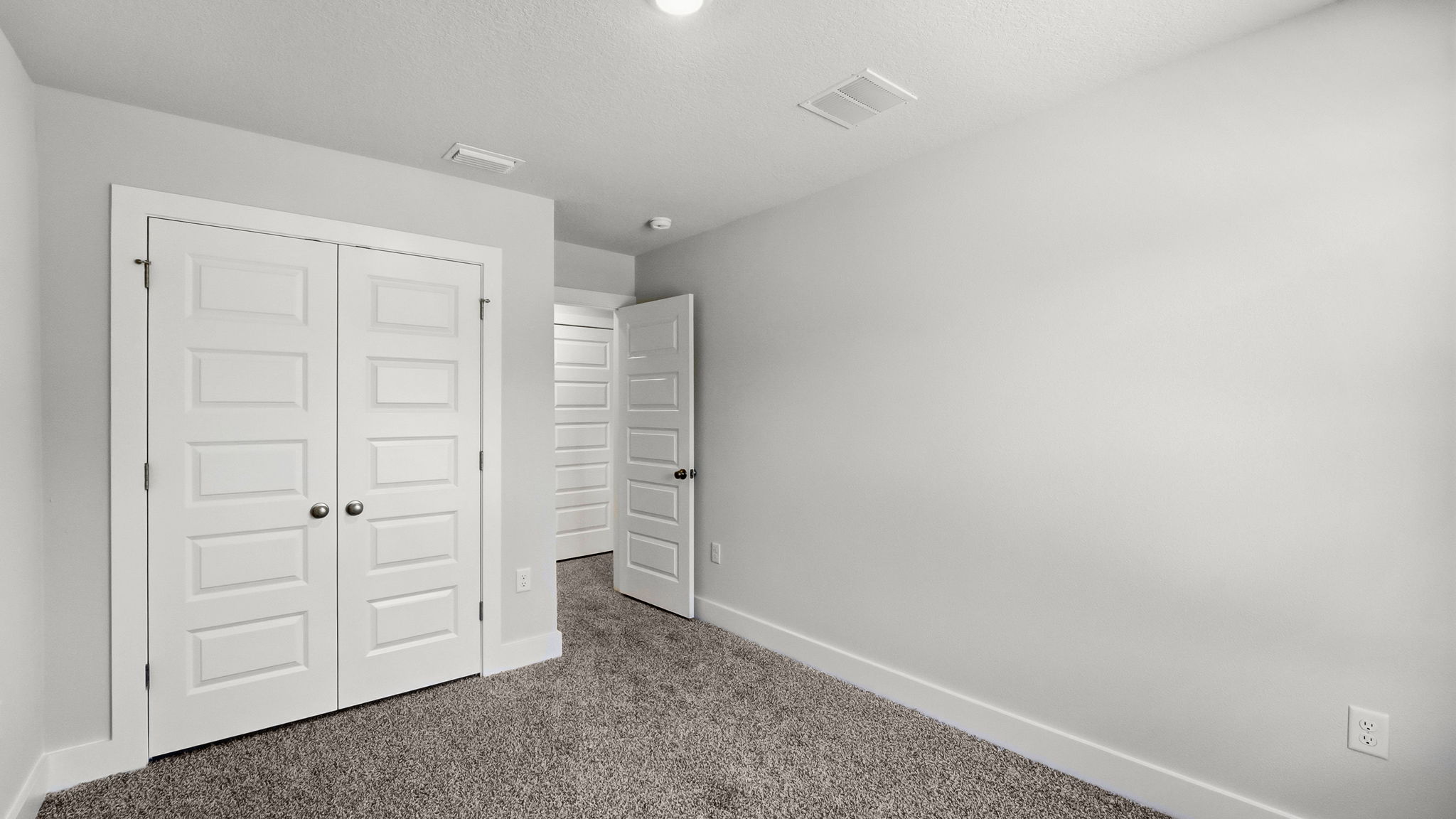 Bedroom with carpet flooring and closet.