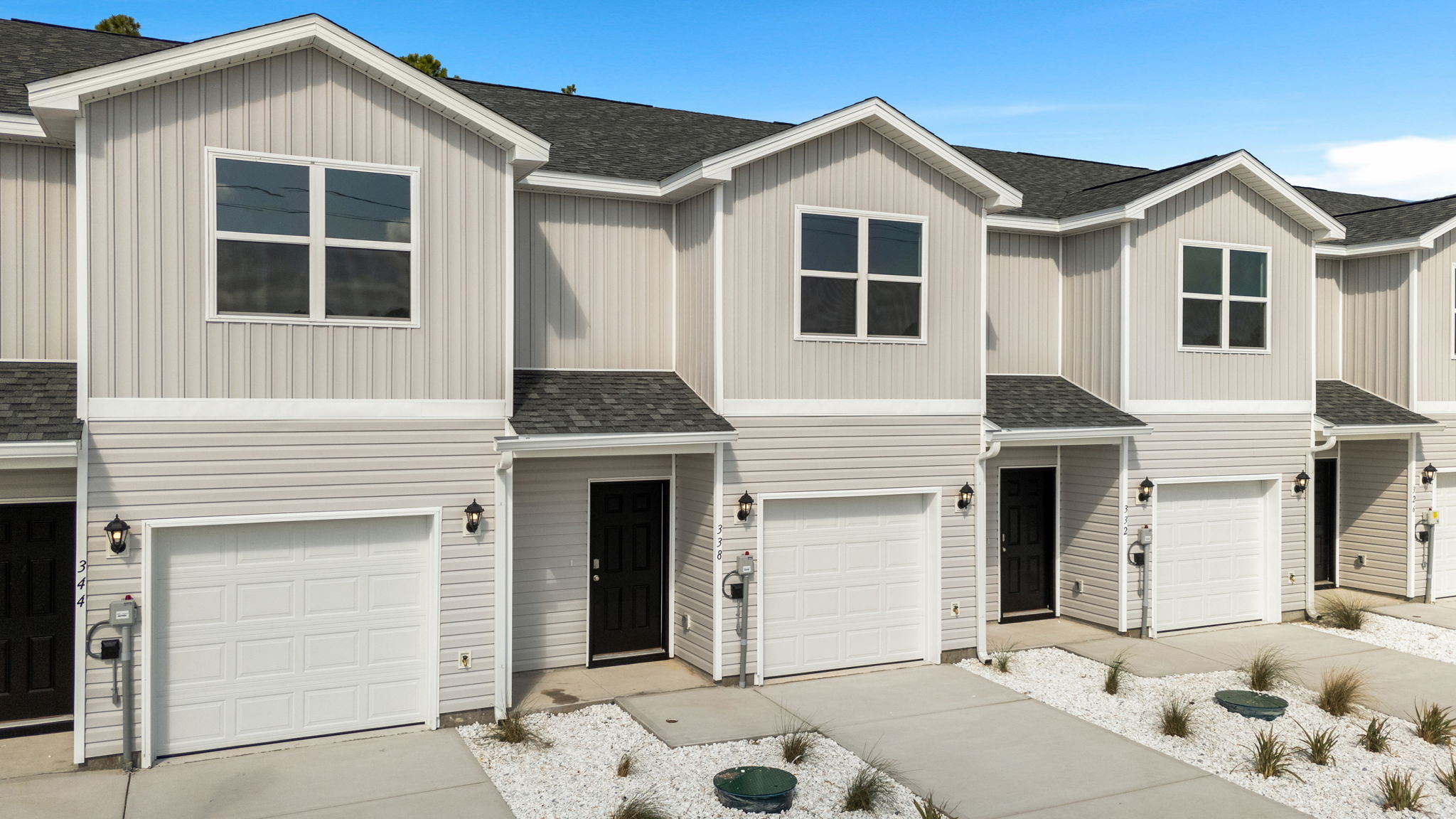 Sabal townhome with single car garage and vinyl siding.