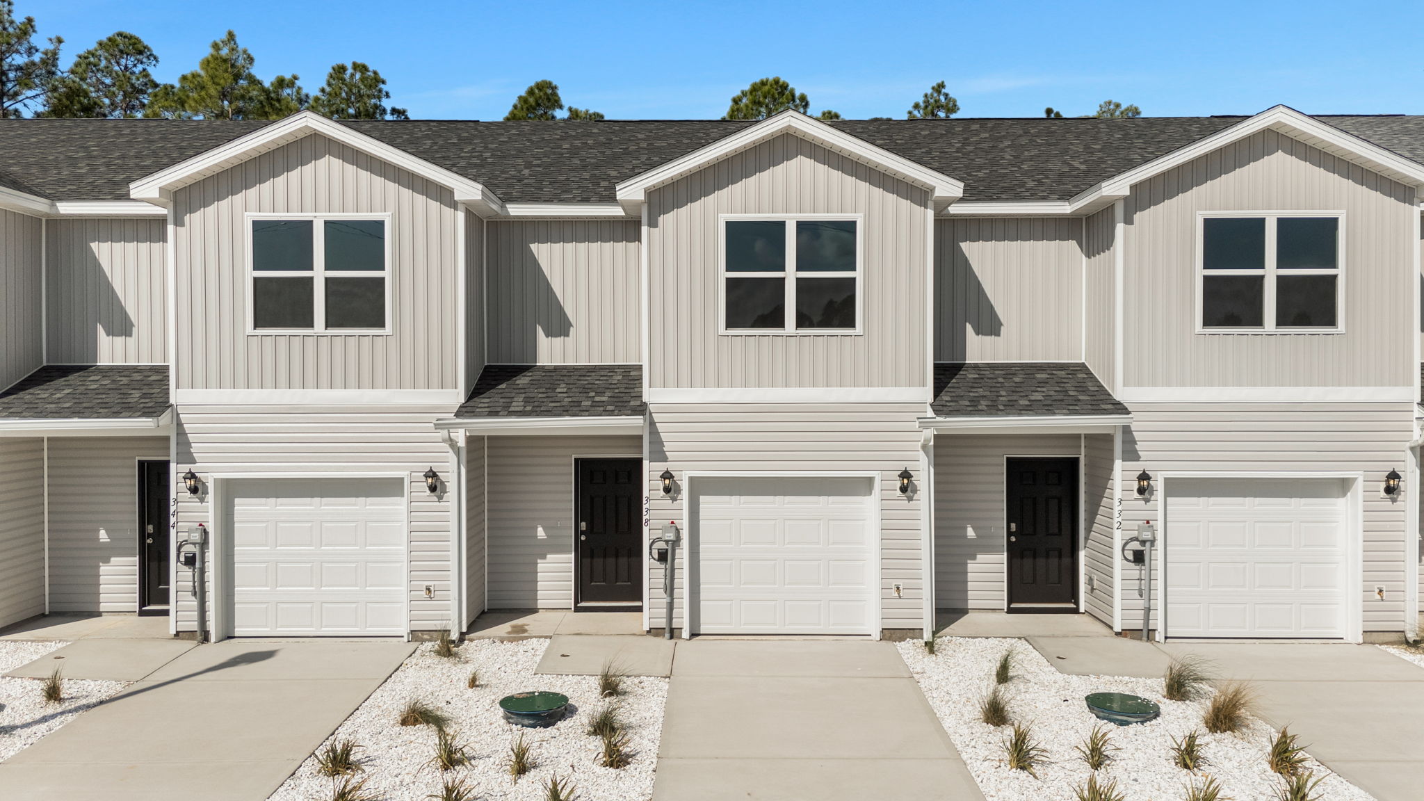 Sabal townhome with single car garage and vinyl siding.