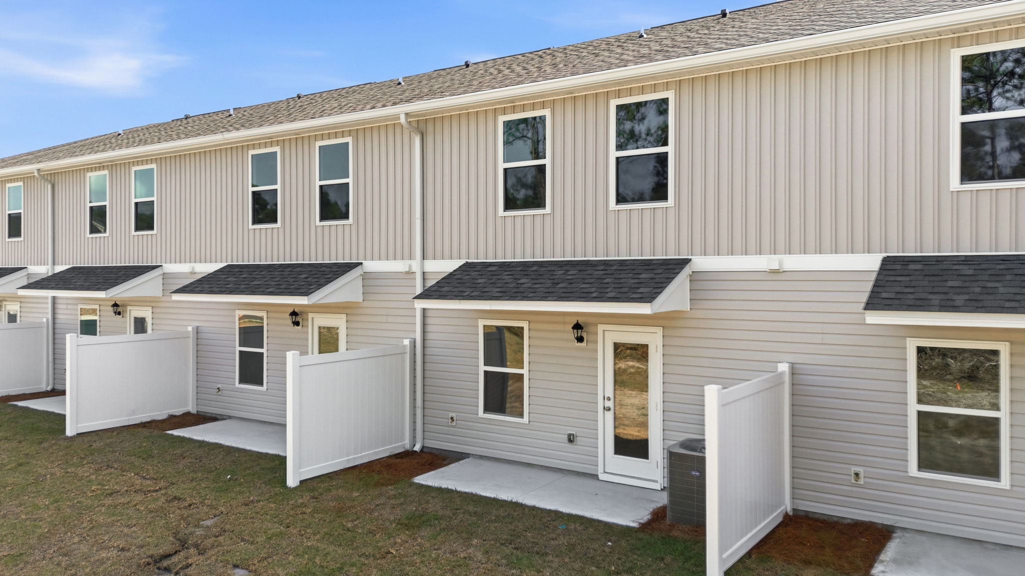 Covered back porch with air-conditioning unit.