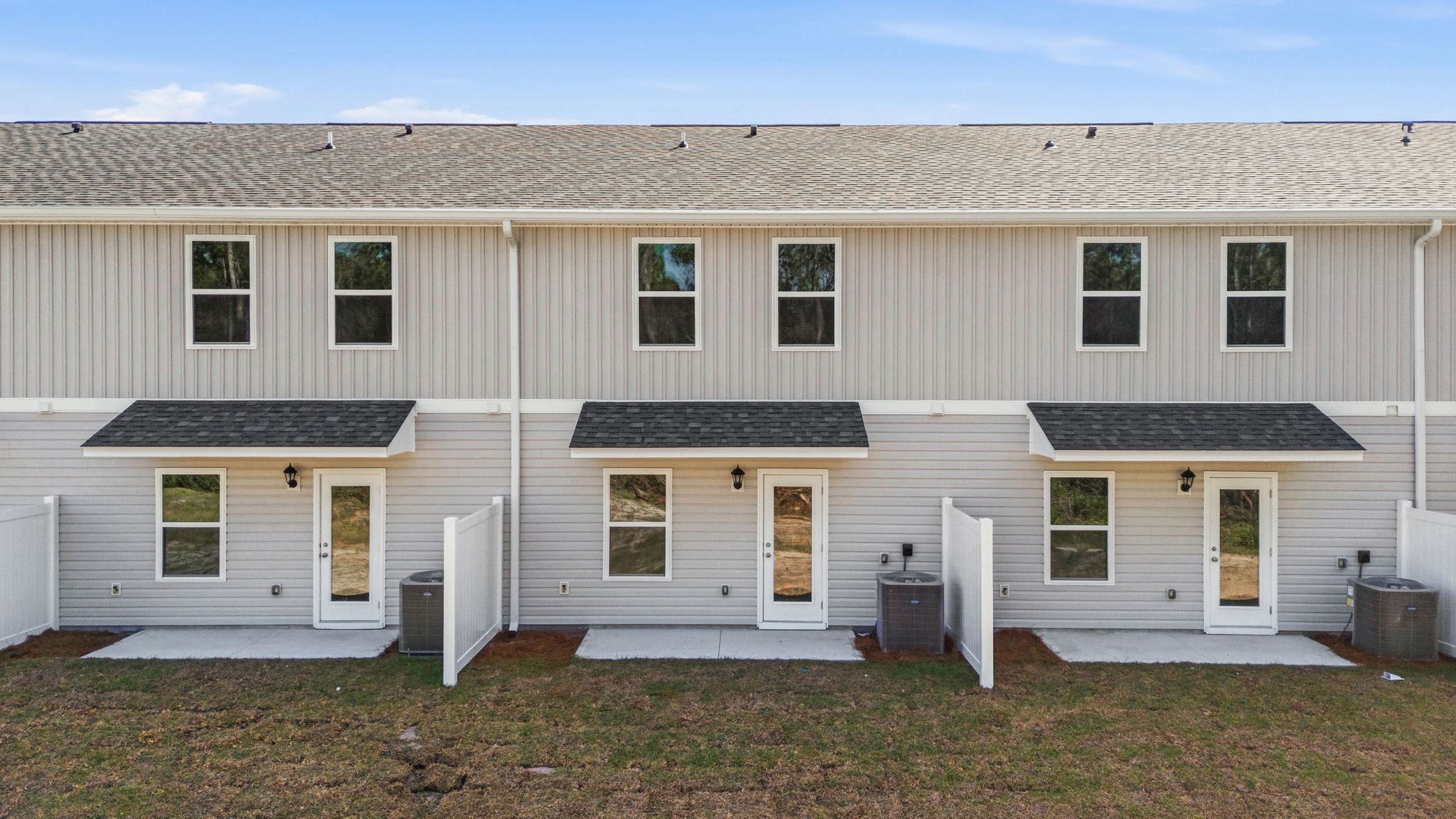 Covered back porch with air-conditioning unit.