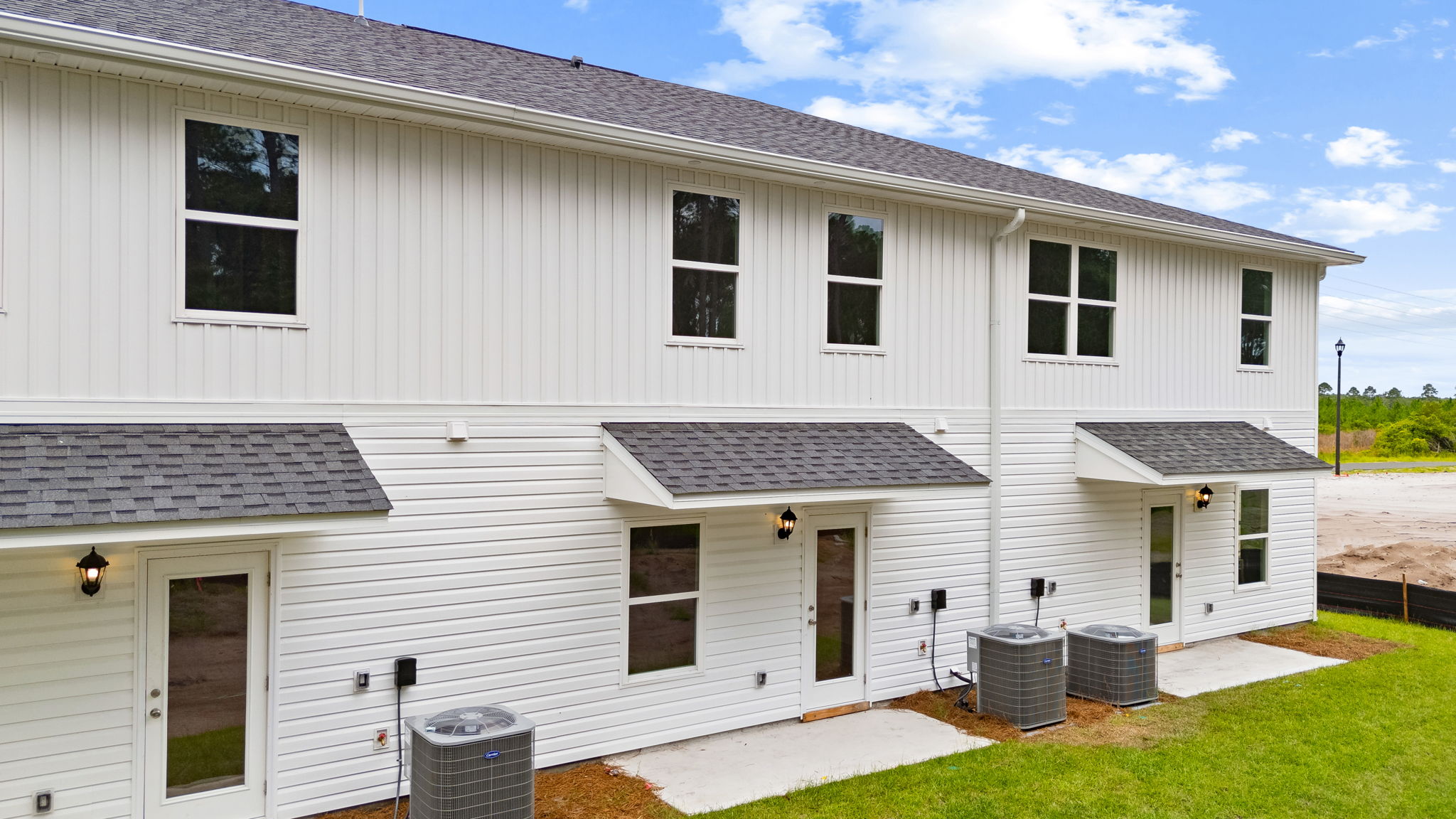 Covered back porch with air-conditioning unit.