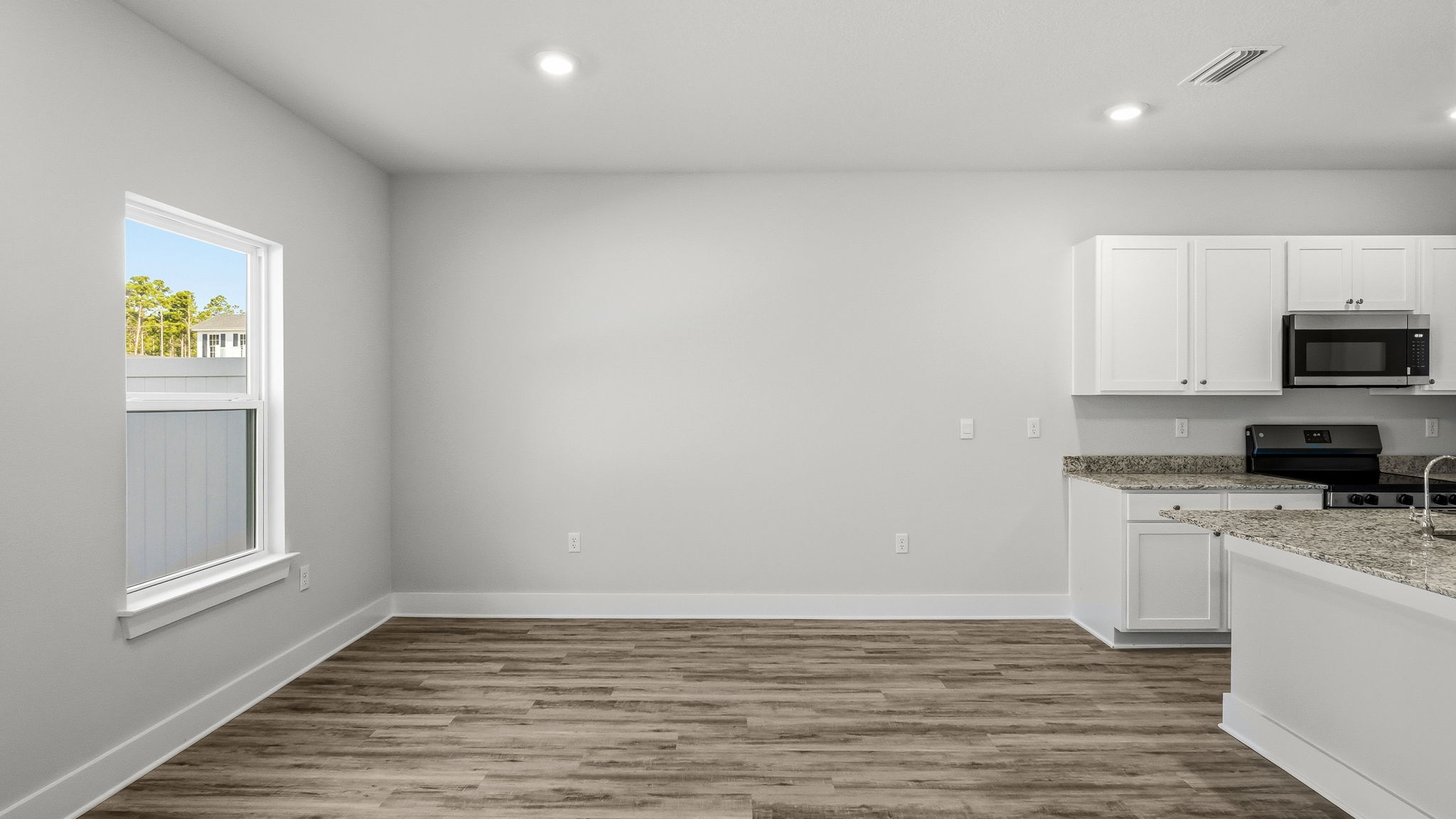 Dining area next to kitchen with window.
