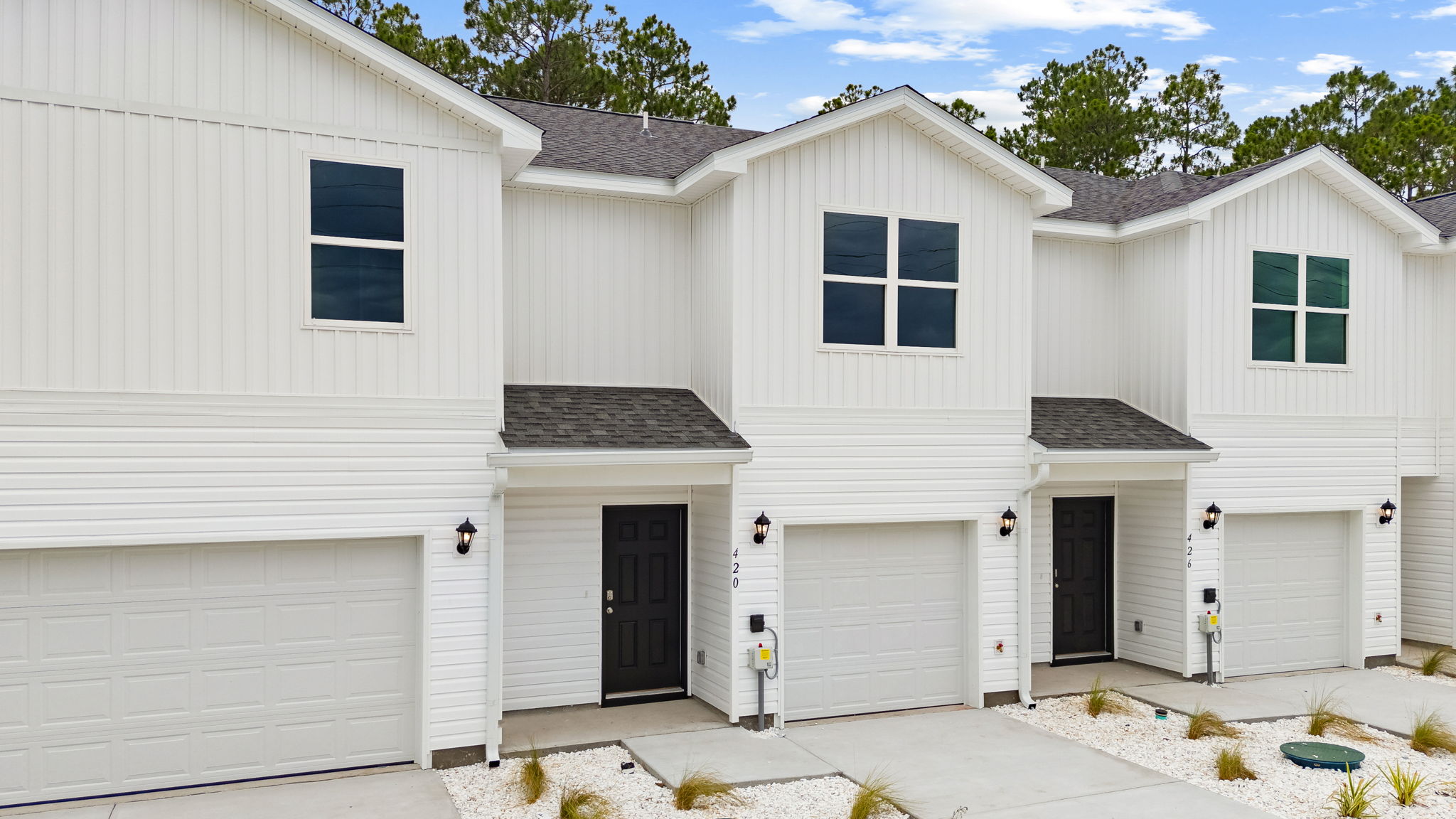 Sabal townhome with single car garage and vinyl siding.