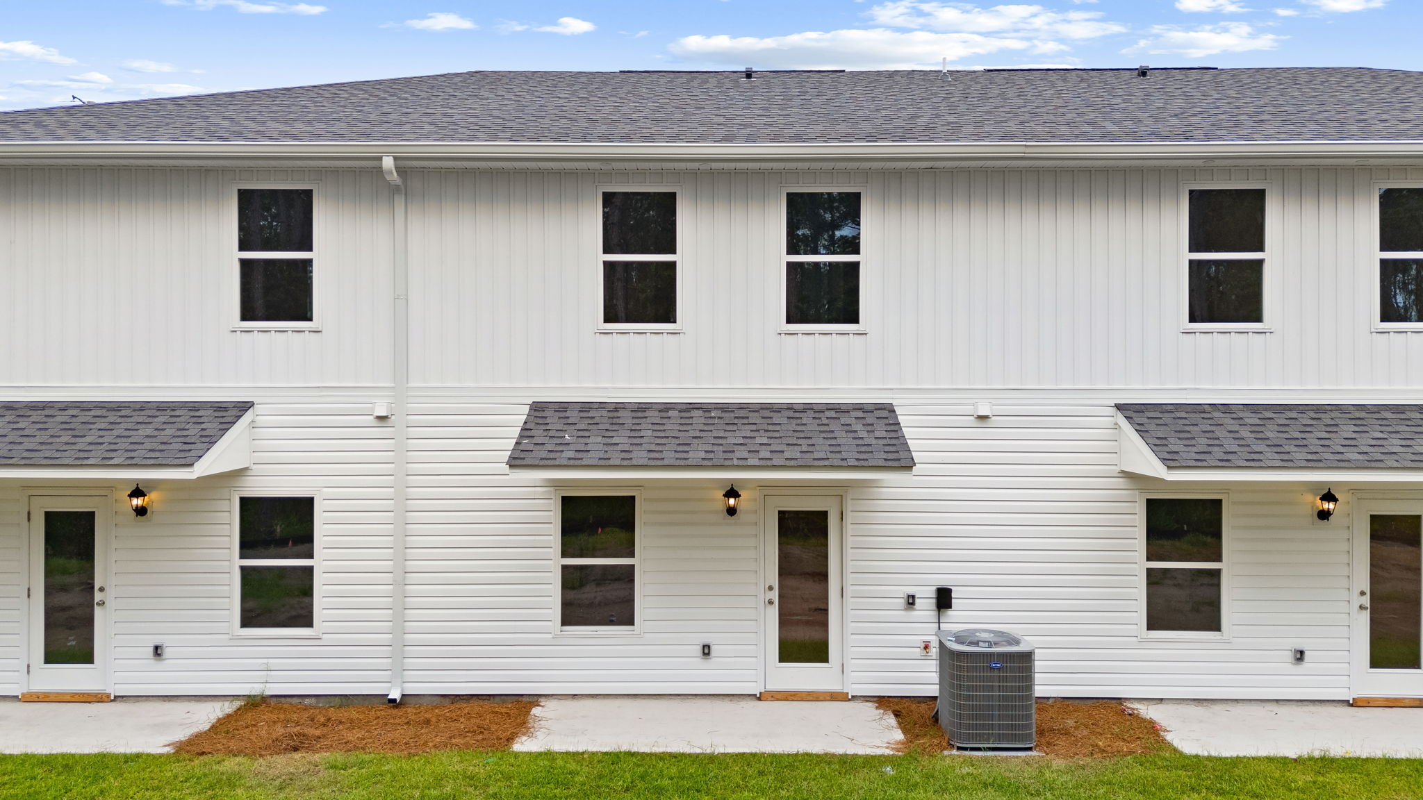 Covered back porch with air-conditioning unit.