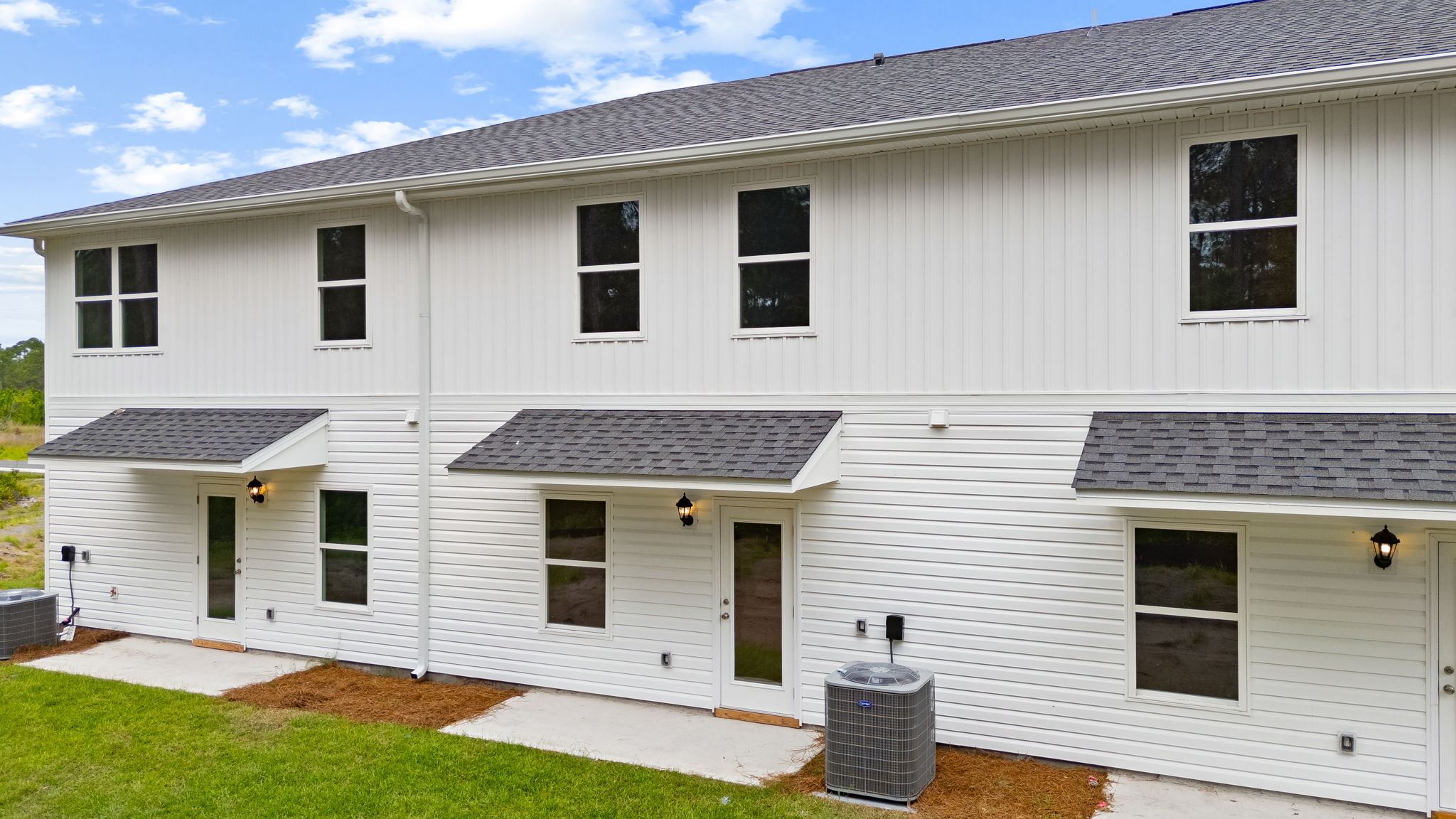 Covered back porch with air-conditioning unit.