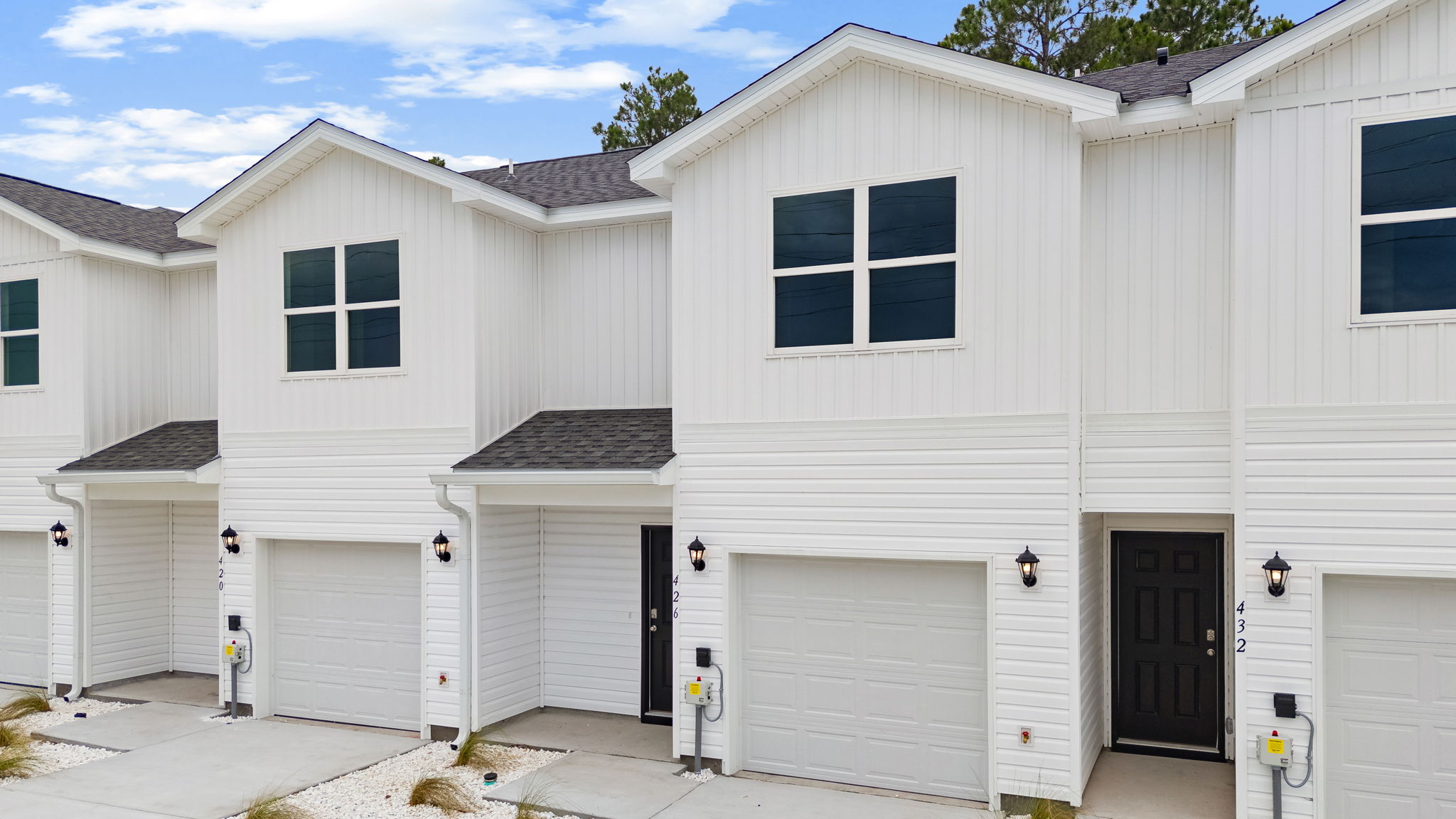Sabal townhome with single car garage and vinyl siding.