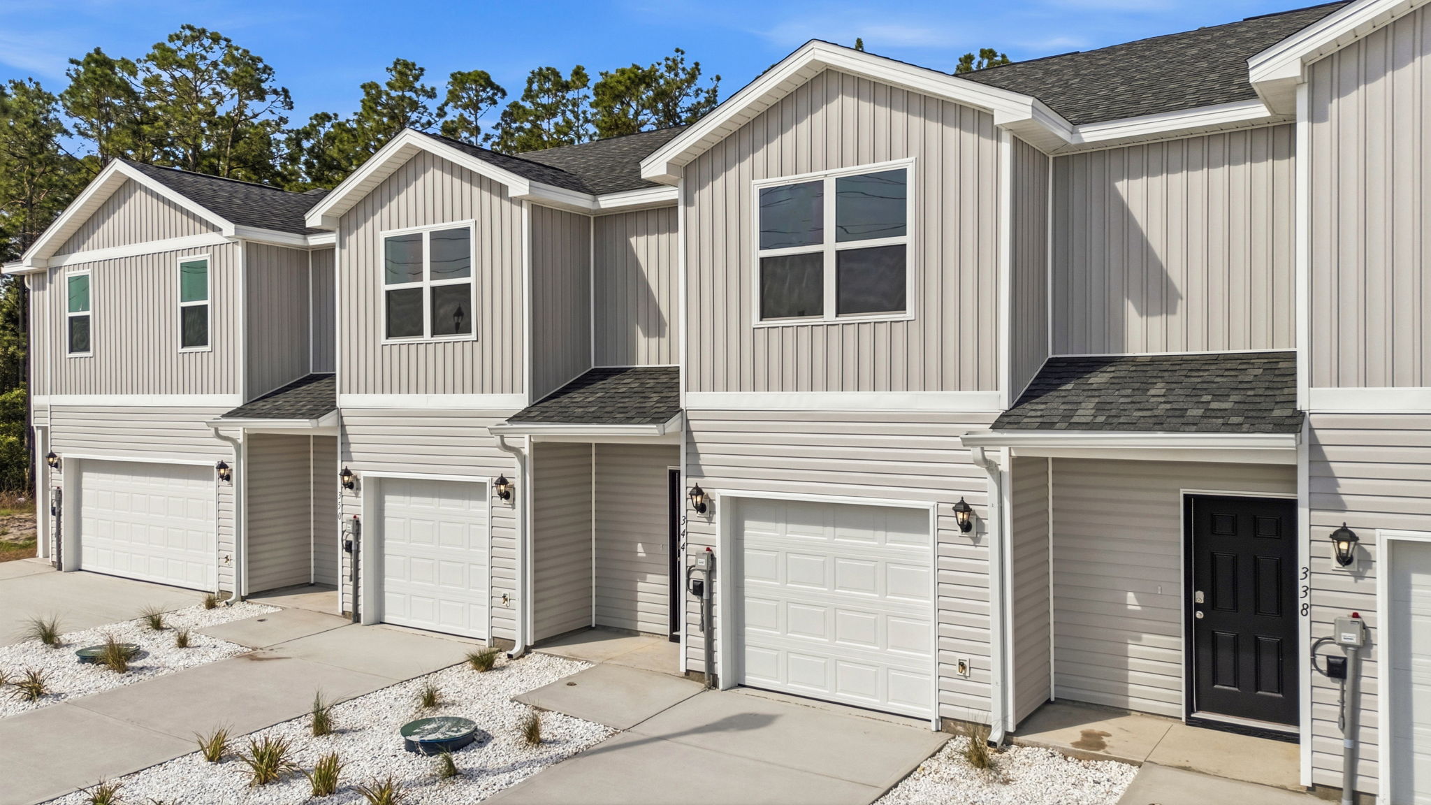 Sabal townhome with single car garage and vinyl siding.