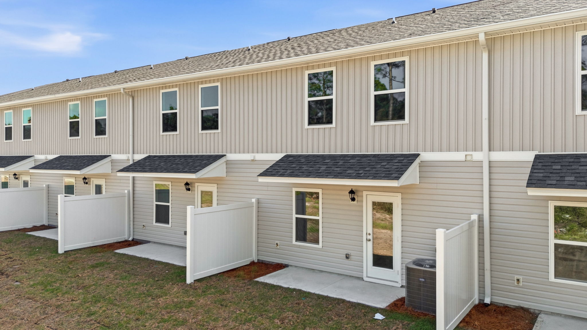 Covered back porch with air-conditioning unit.