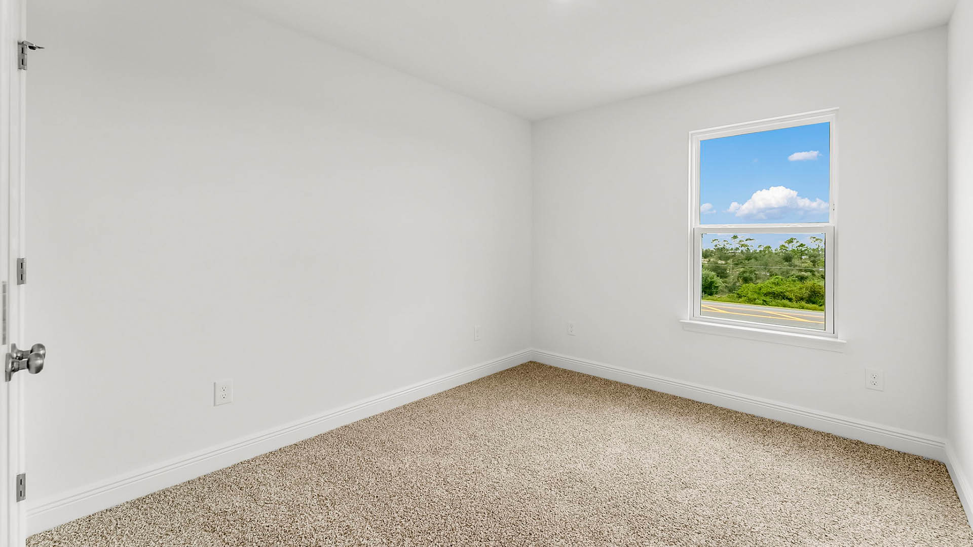 Bedroom with carpet floors and window.