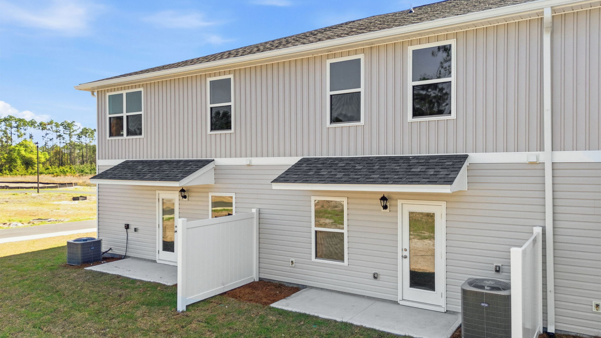 Covered back porch with air-conditioning unit.
