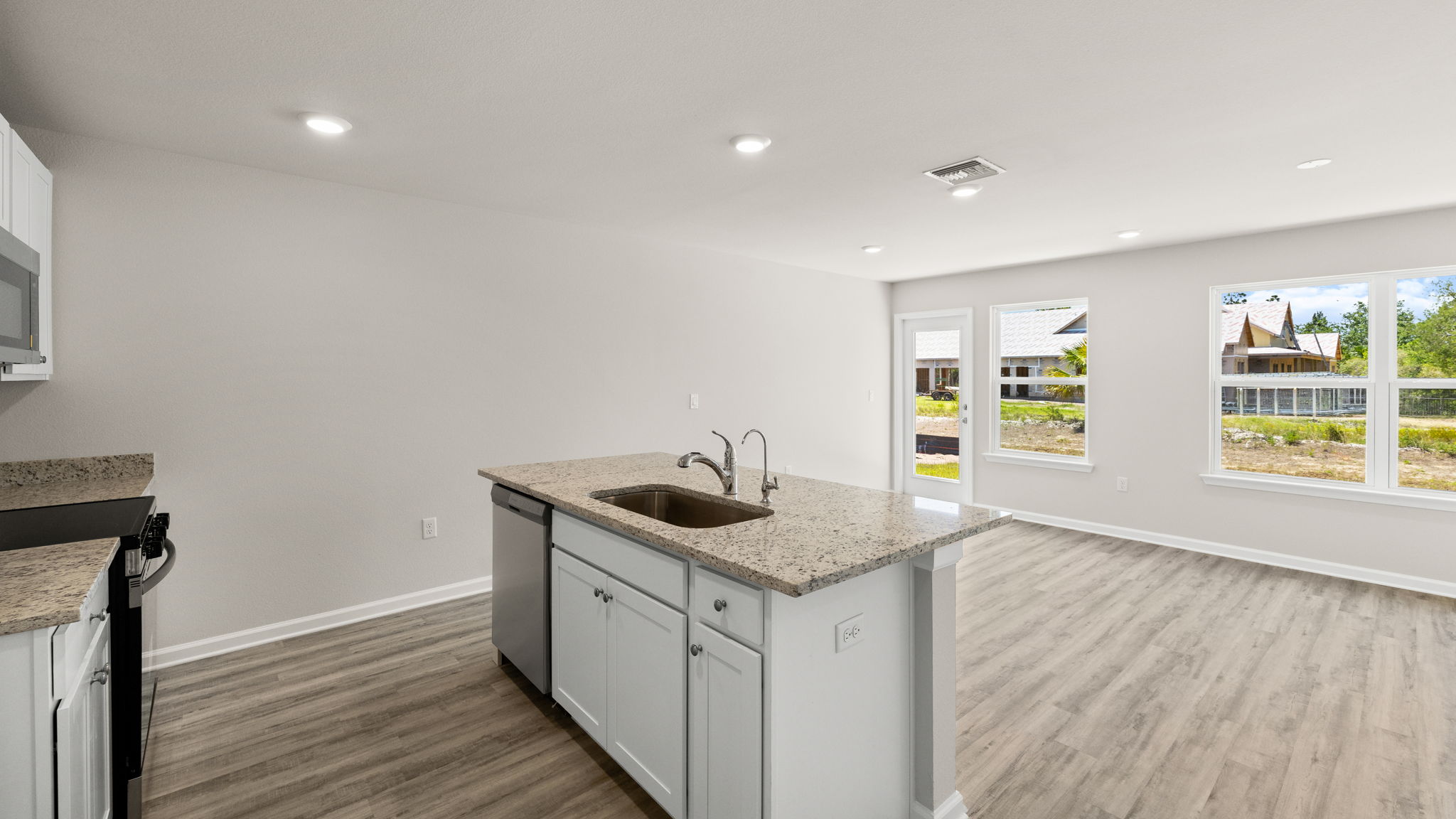 Open kitchen with island and living room.