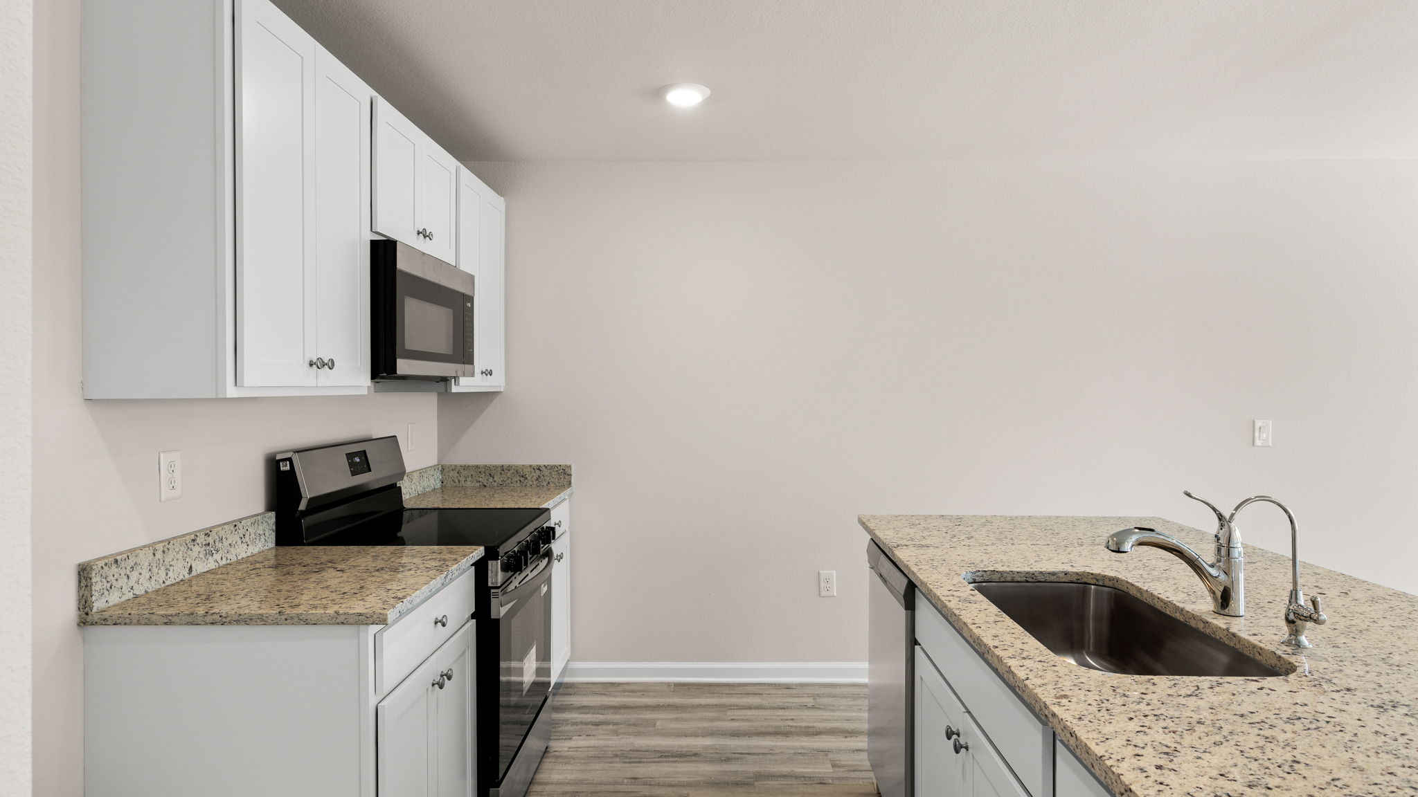 Kitchen with granite countertops and stainless-steel appliances.