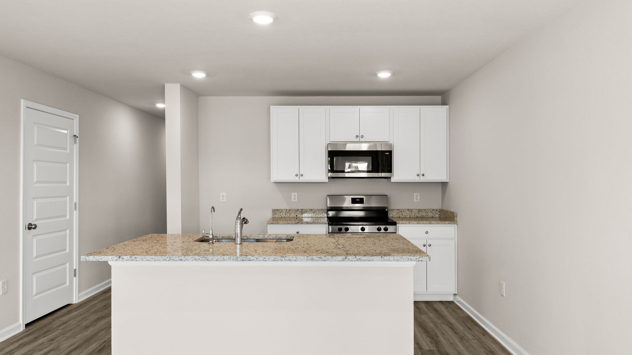 Kitchen with granite countertops and stainless-steel appliances.