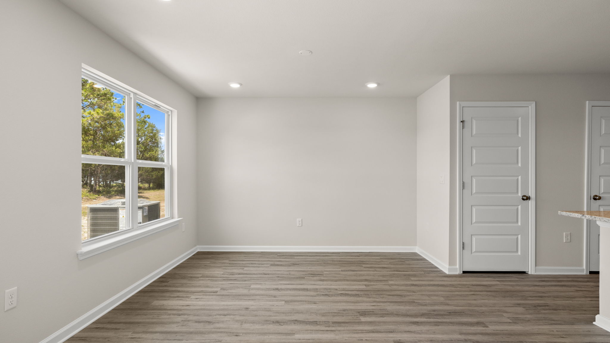 Living room with EVP flooring and windows.