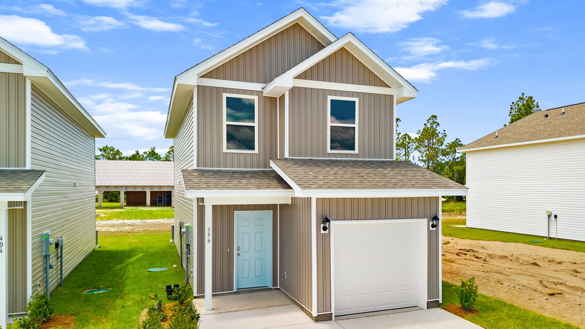 Alderbrook plan with vinyl siding and covered front porch.