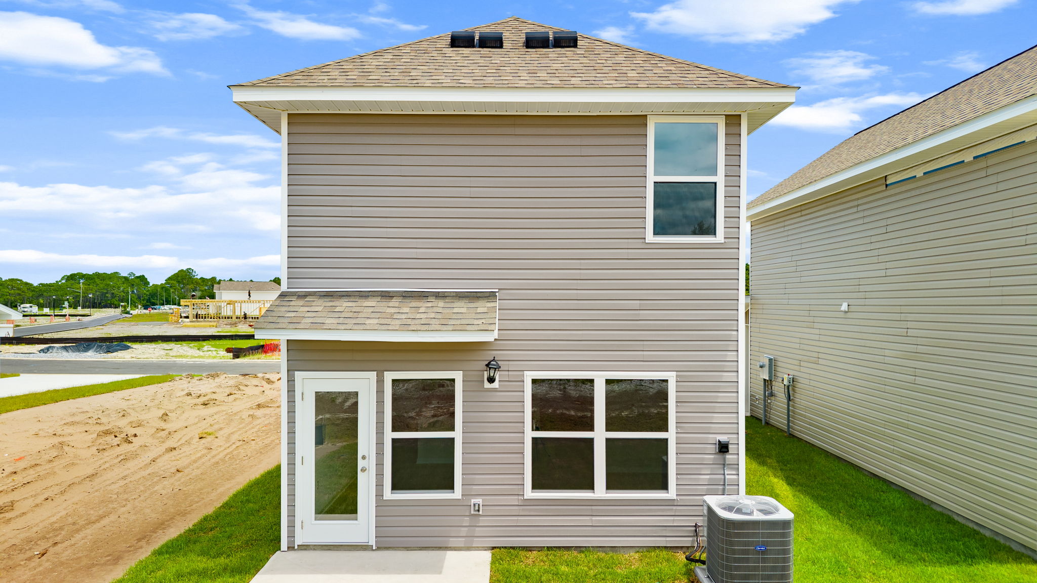 Alderbrook plan rear of home with vinyl siding and back patio.