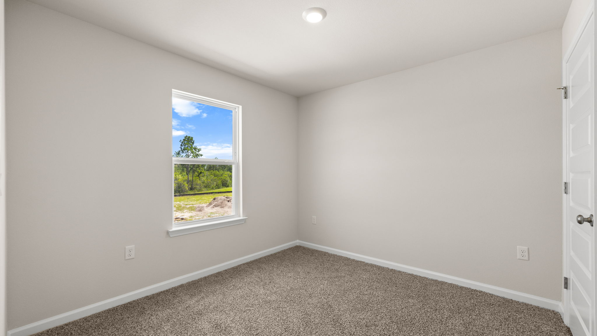 Bedroom with carpet floor and window.