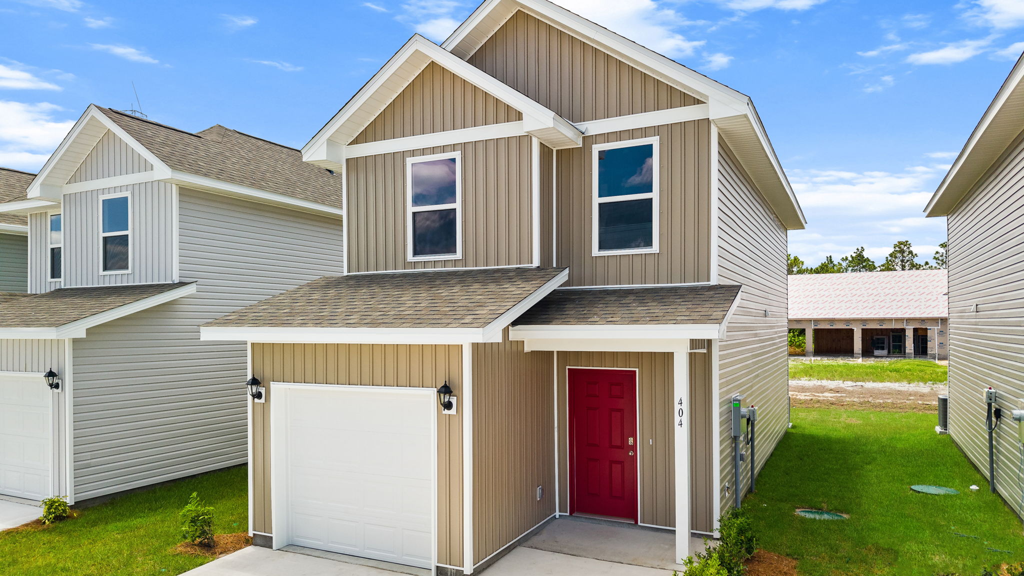 Alderbrook plan with vinyl siding and covered front porch.