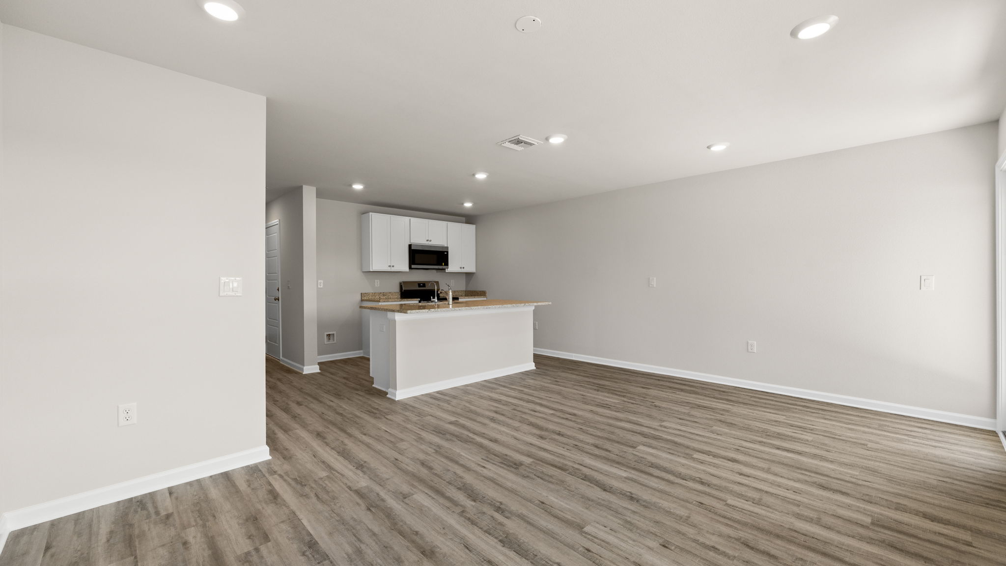 Open kitchen with island and living room.