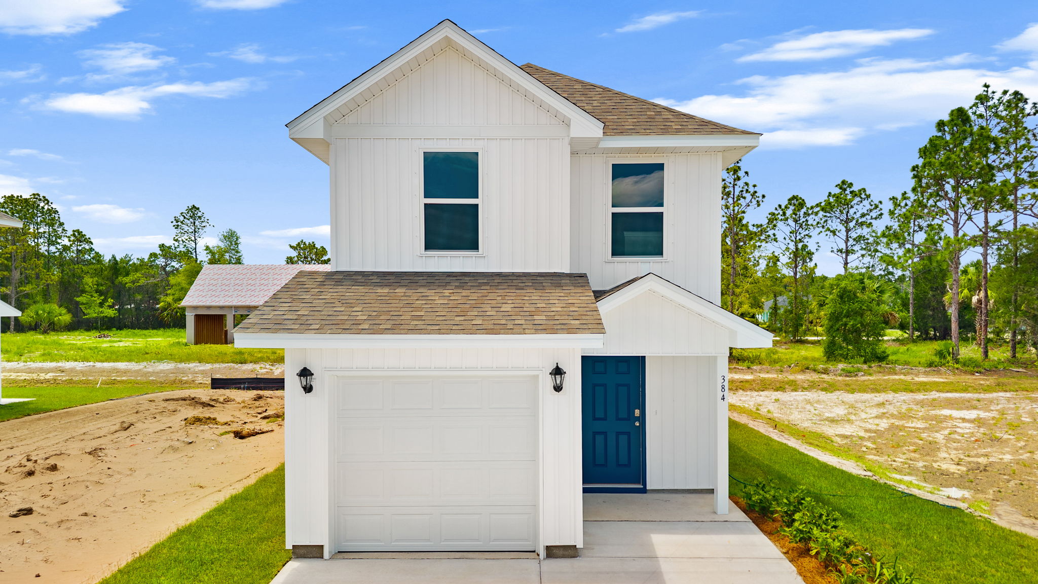 Alderbrook plan with vinyl siding and covered front porch.