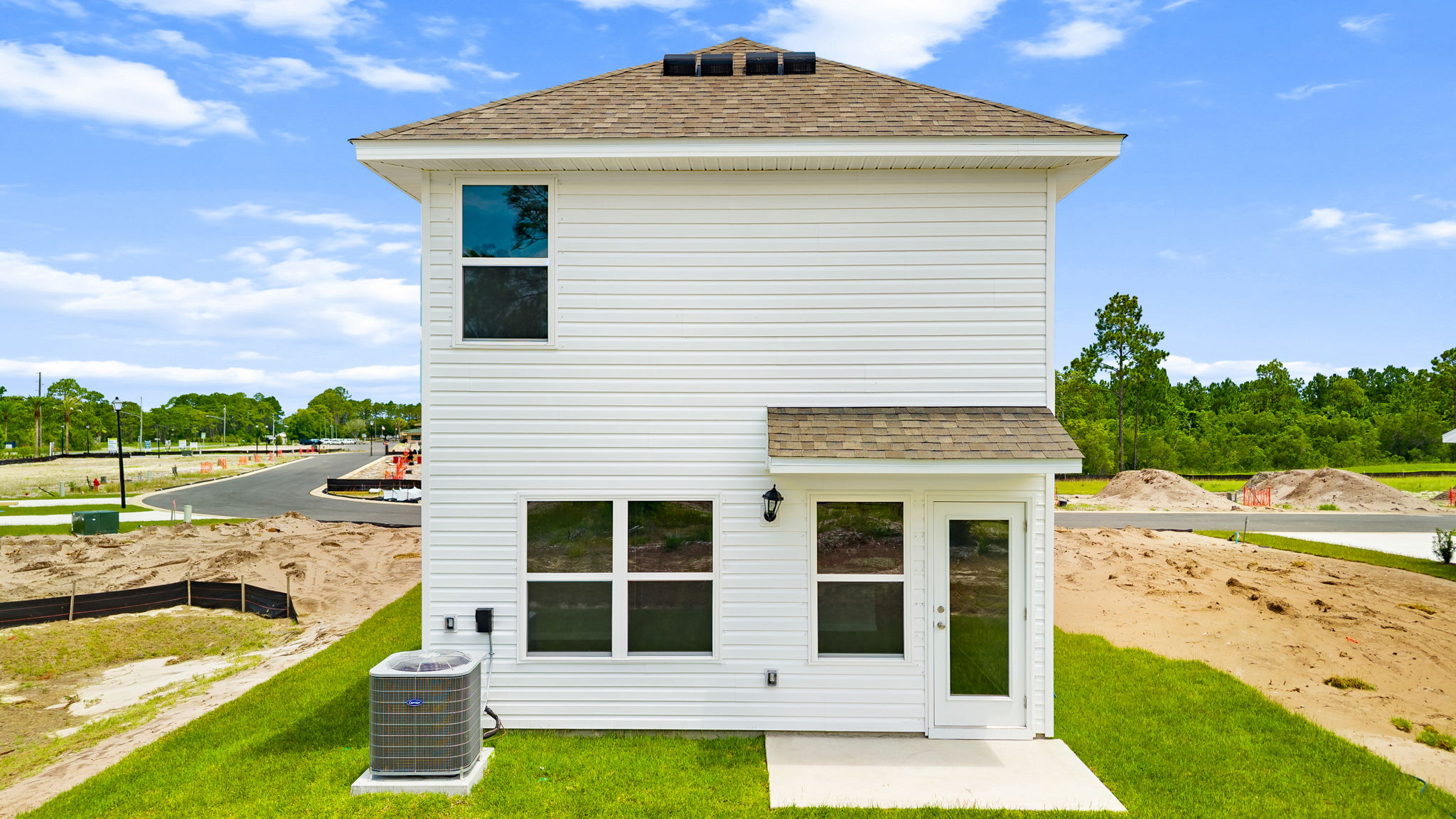 Canmore plan rear of home with vinyl siding and back patio.