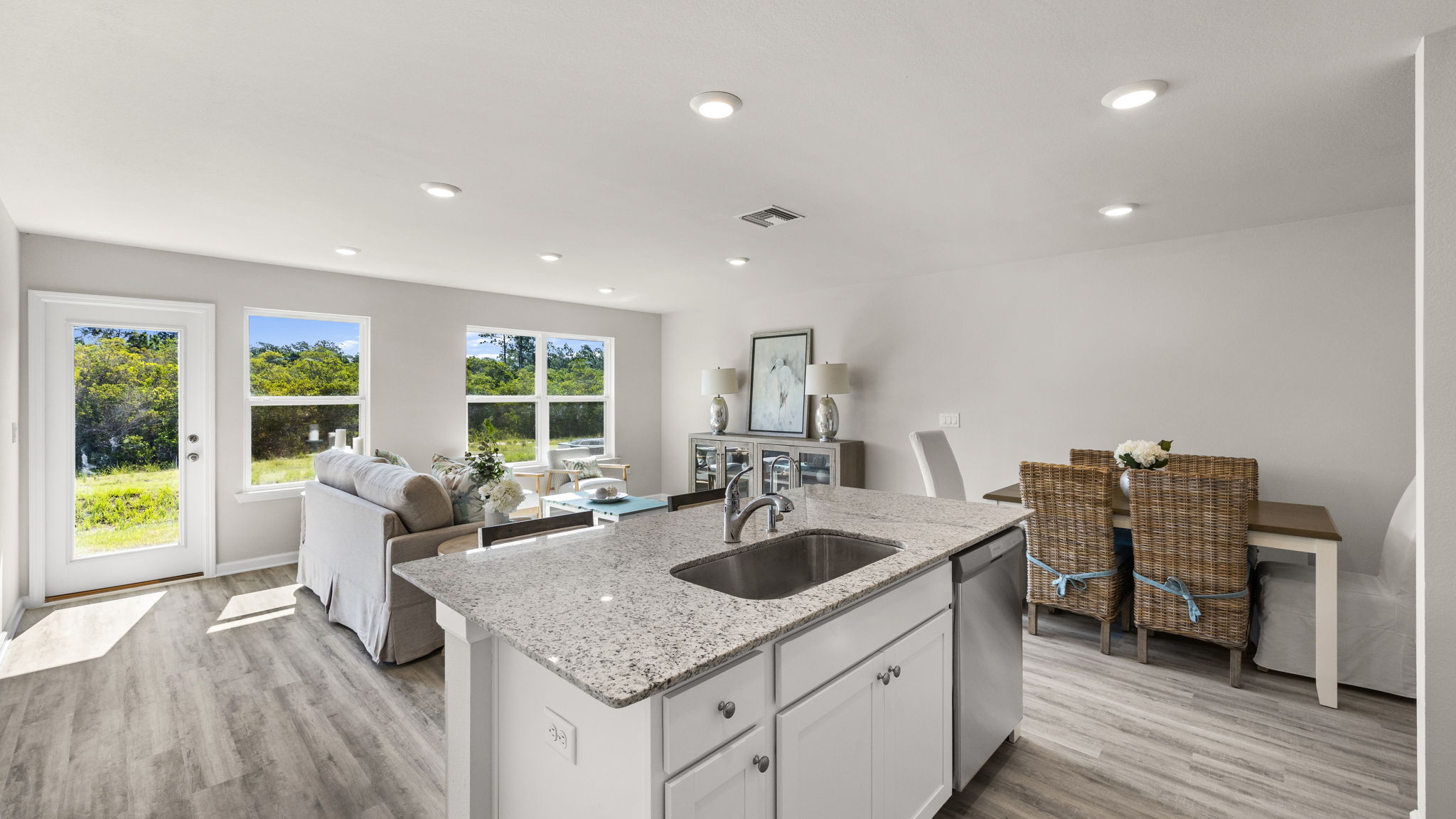 Open living room view and kitchen with kitchen island.