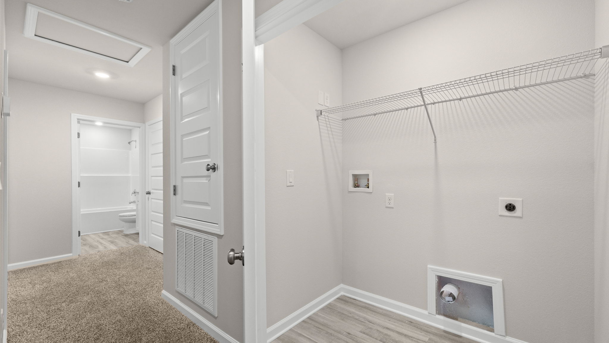 Upstairs laundry room next to bedrooms.