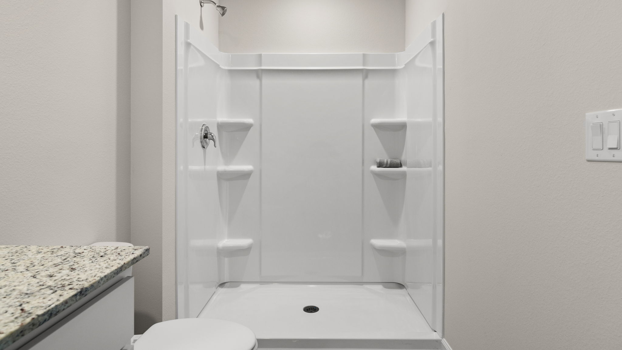 Primary bathroom shower and toilet.