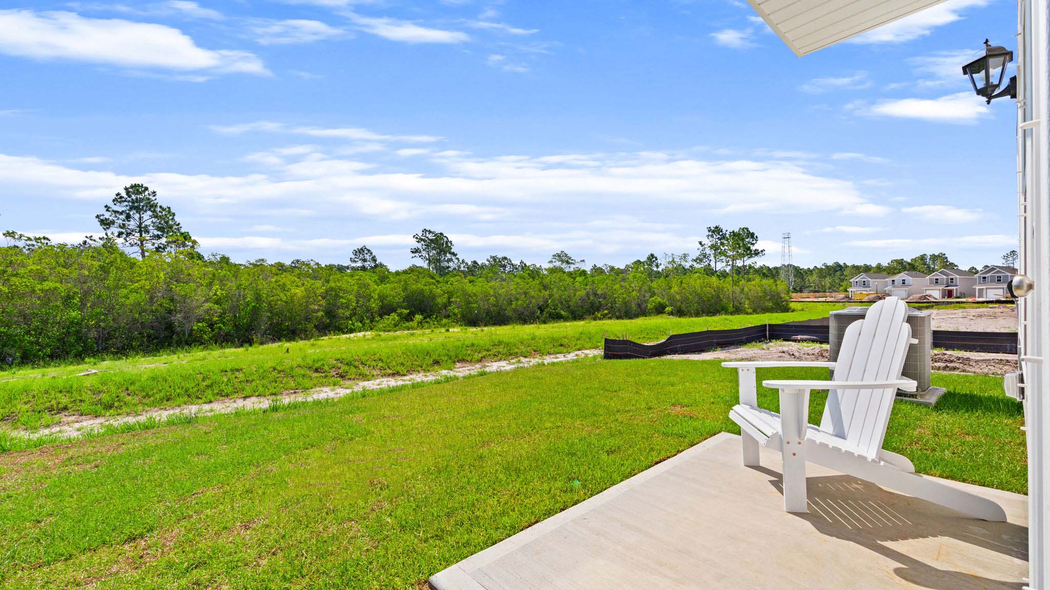 Back yard view with concrete pad.