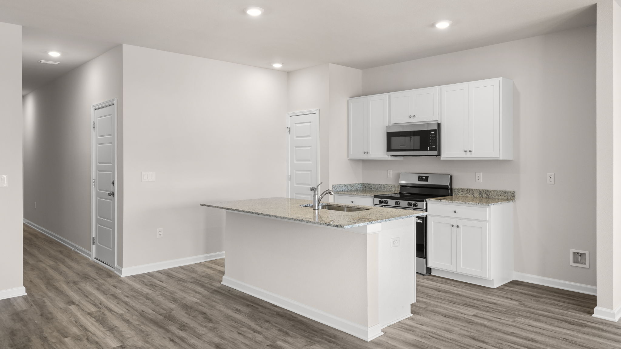 Kitchen with granite countertops and stainless-steel appliances.