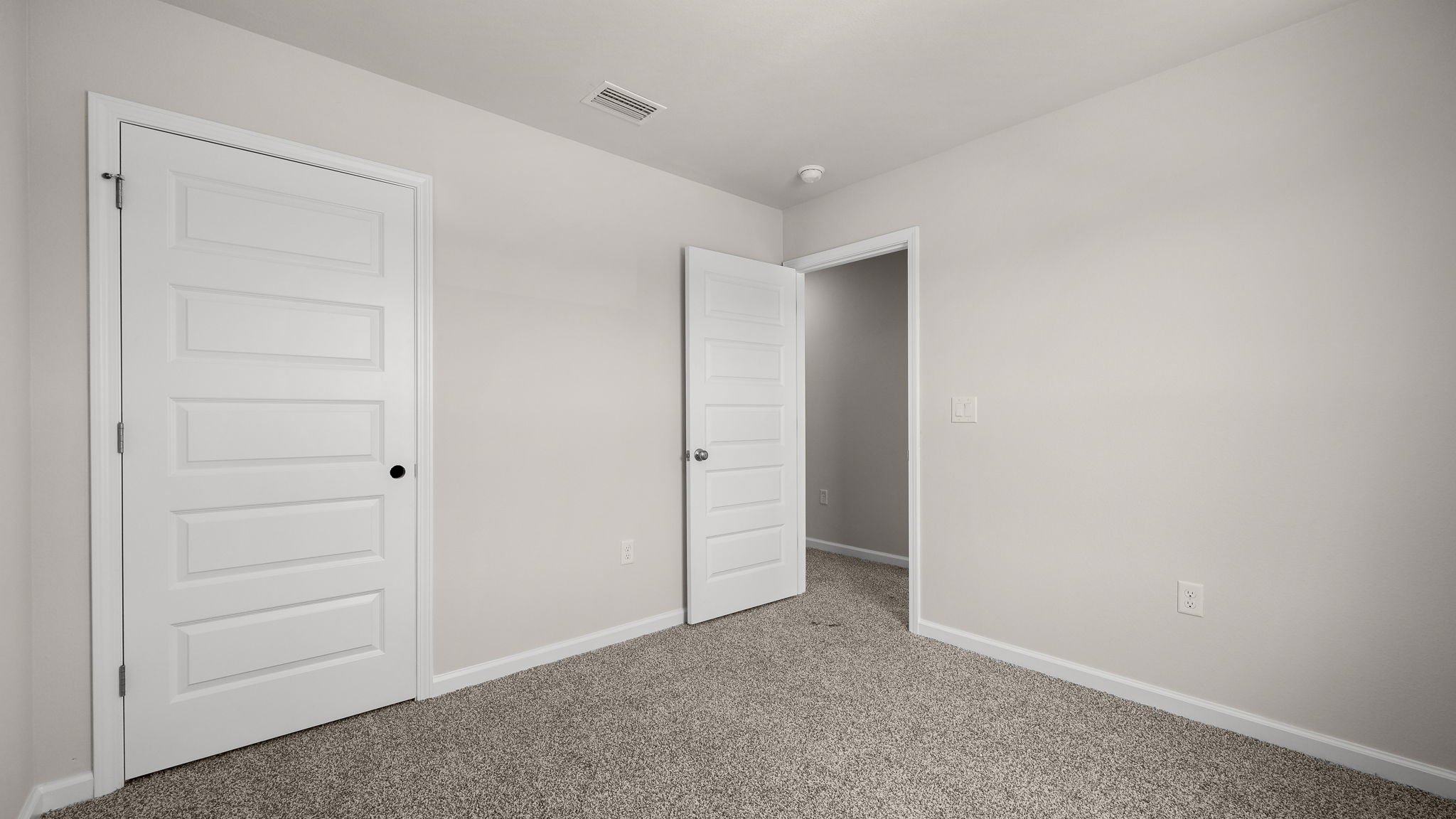 Bedroom with carpet floor and closet.
