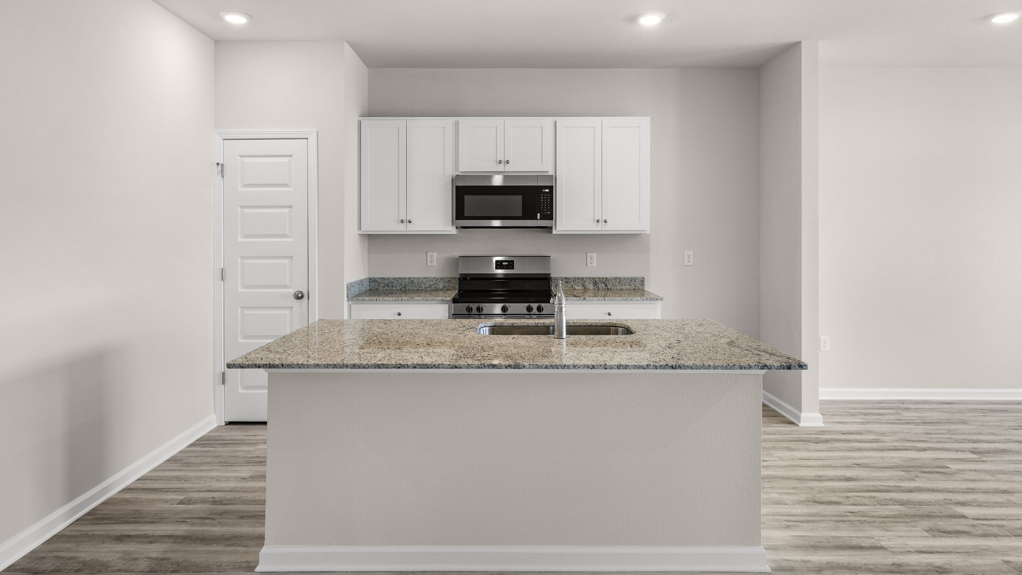 Kitchen with granite countertops and stainless-steel appliances.