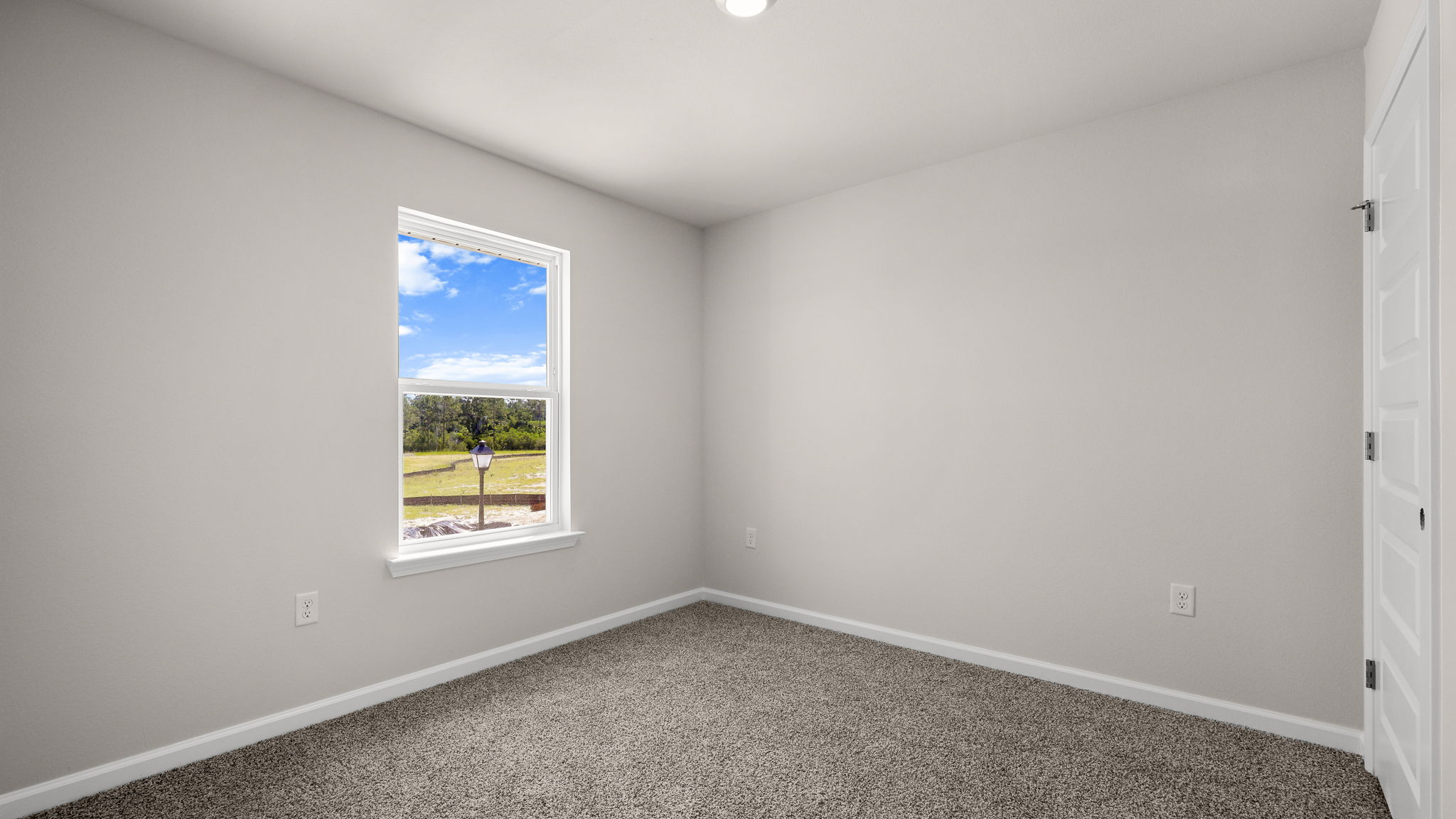 Bedroom with carpet floor and window.