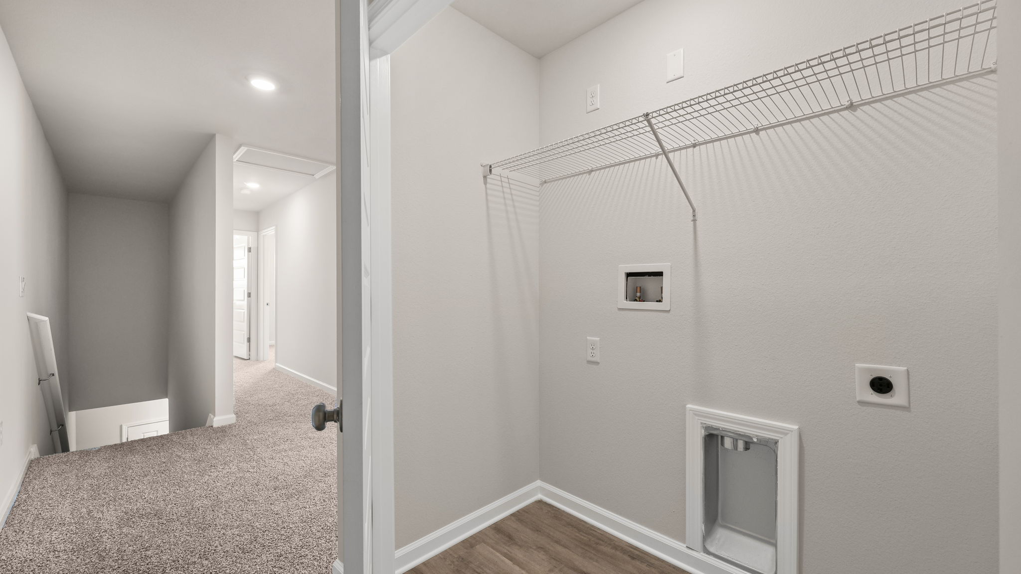 Upstairs laundry room next to bedrooms.