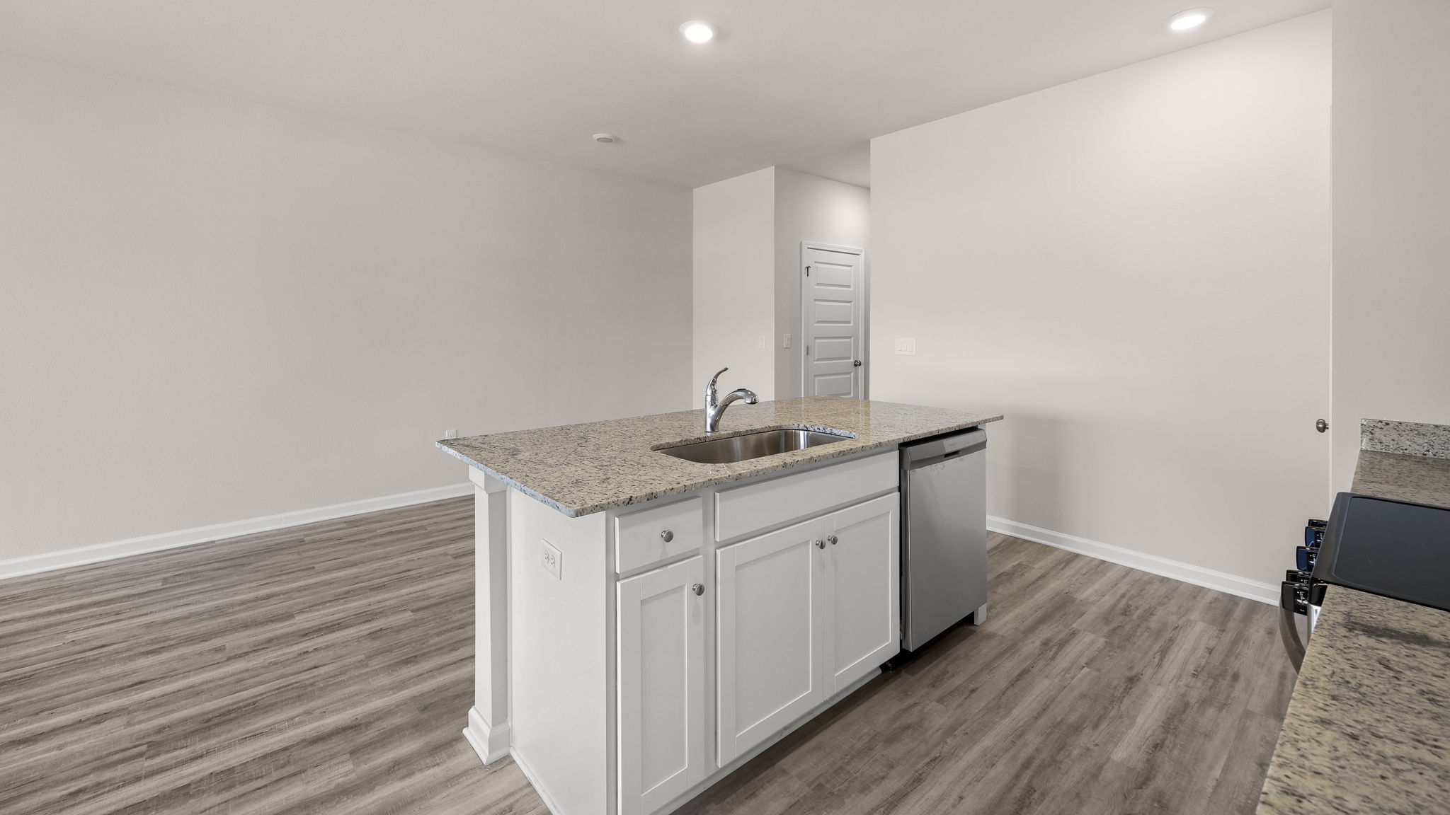 Kitchen with granite countertops and stainless-steel appliances.
