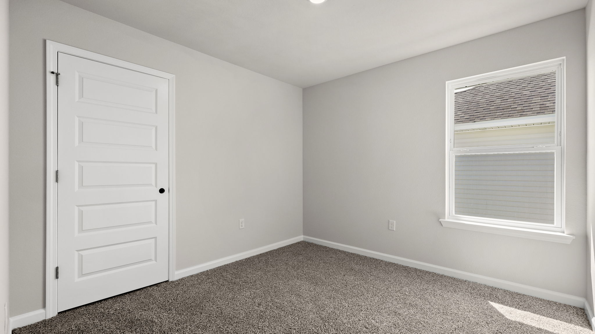 Bedroom with carpet floor and closet and window.