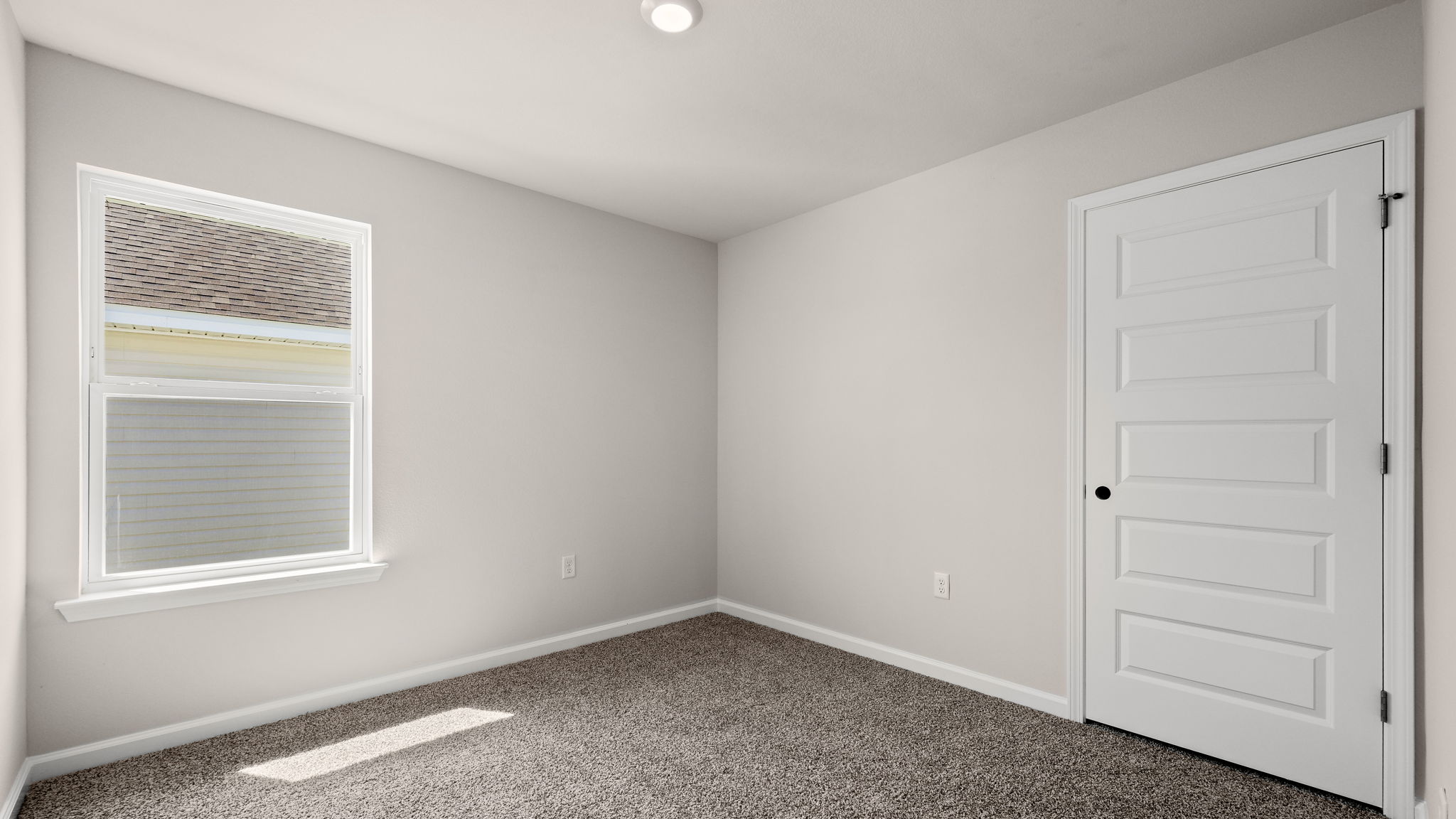 Bedroom with carpet floor and closet and window.