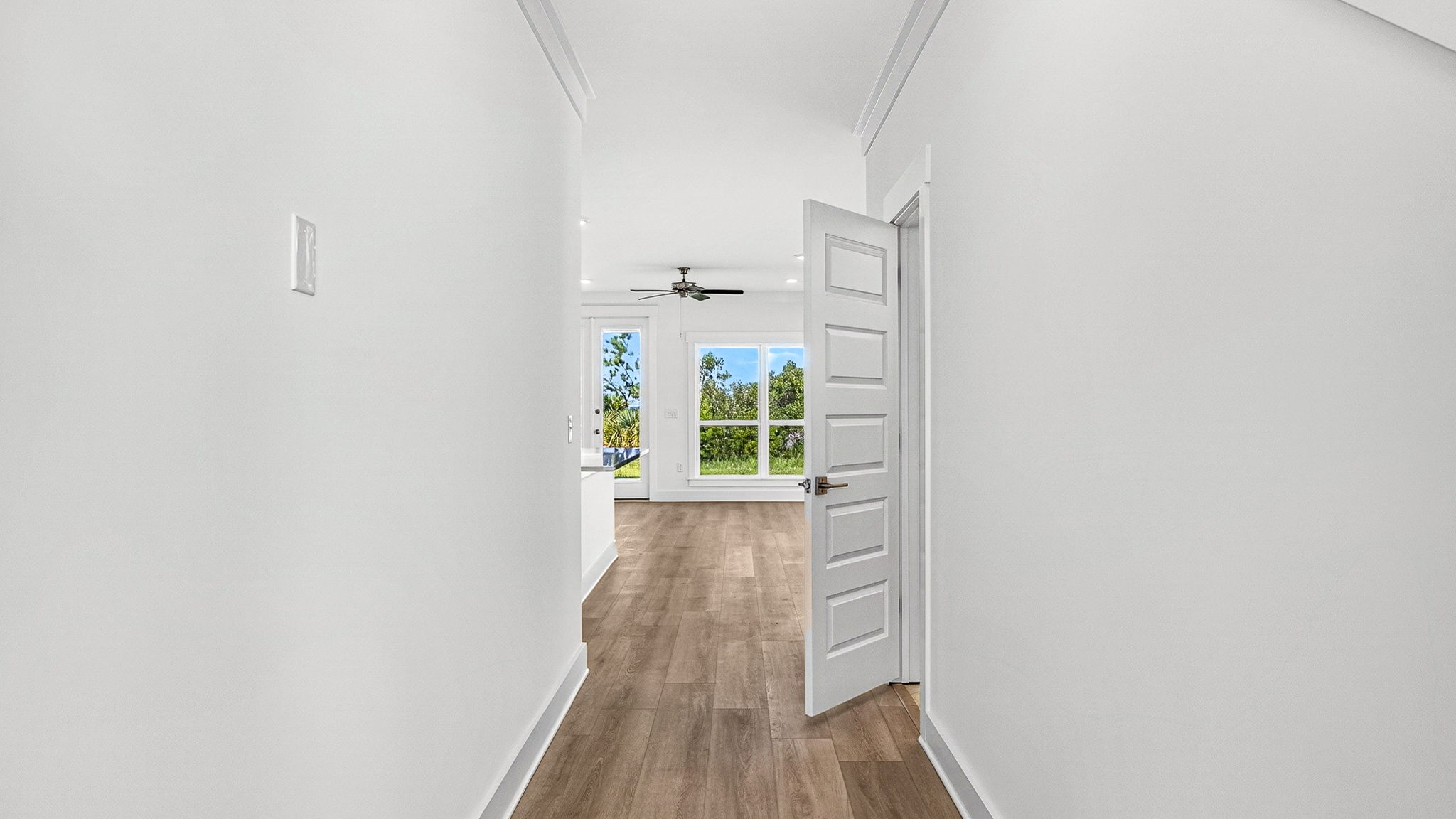 Front entrance hallway with EVP flooring next to half bathroom.