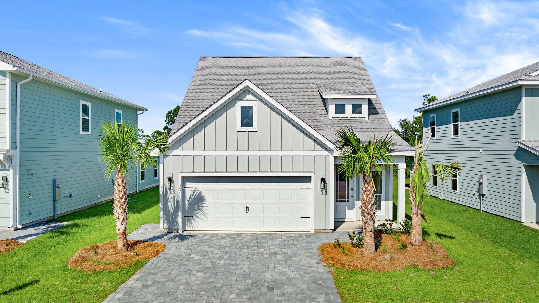 Islamorada plan with covered front porch and two car garage.
