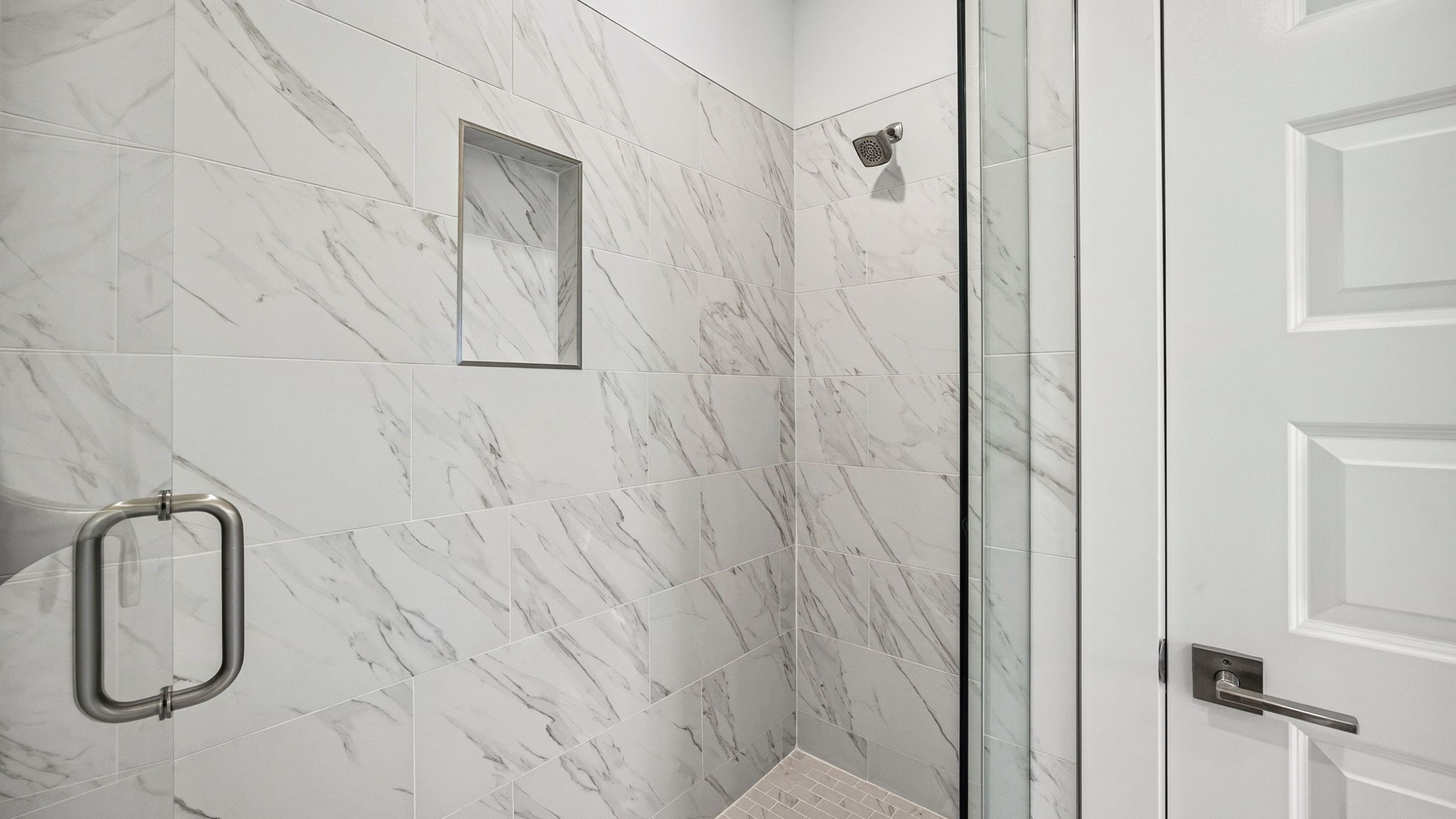 Florentine tile shower with glass door.