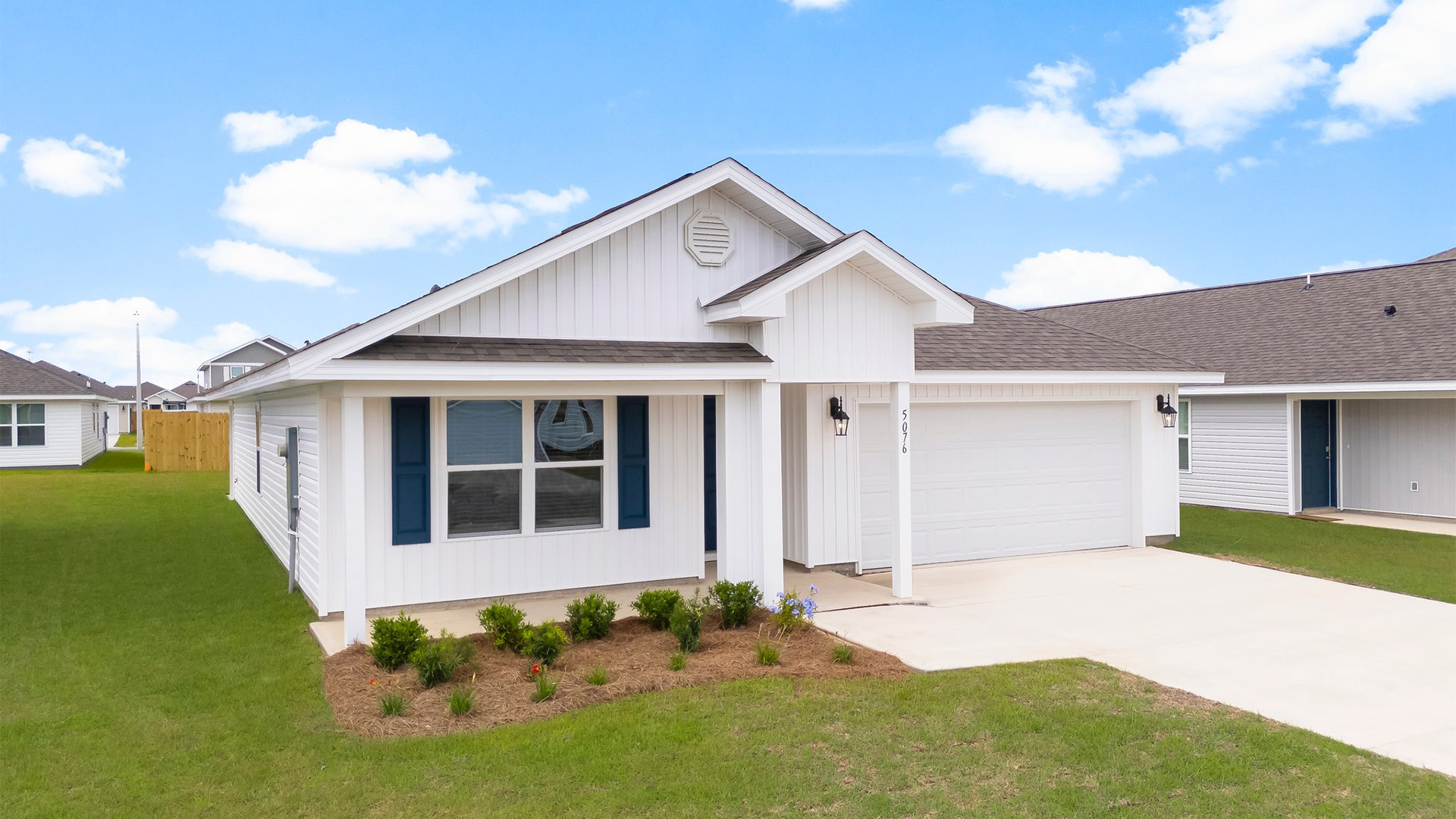 Cali floor plan with vinyl siding and covered front porch and two car garage.