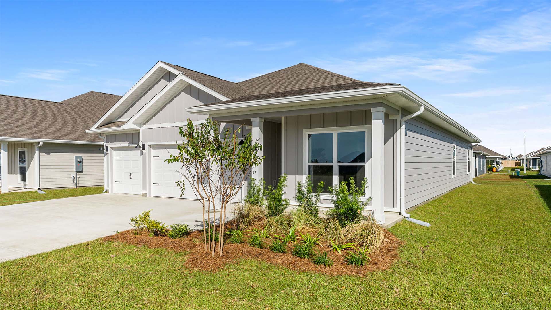 Madison floor plan with 3 car garage and covered front porch.