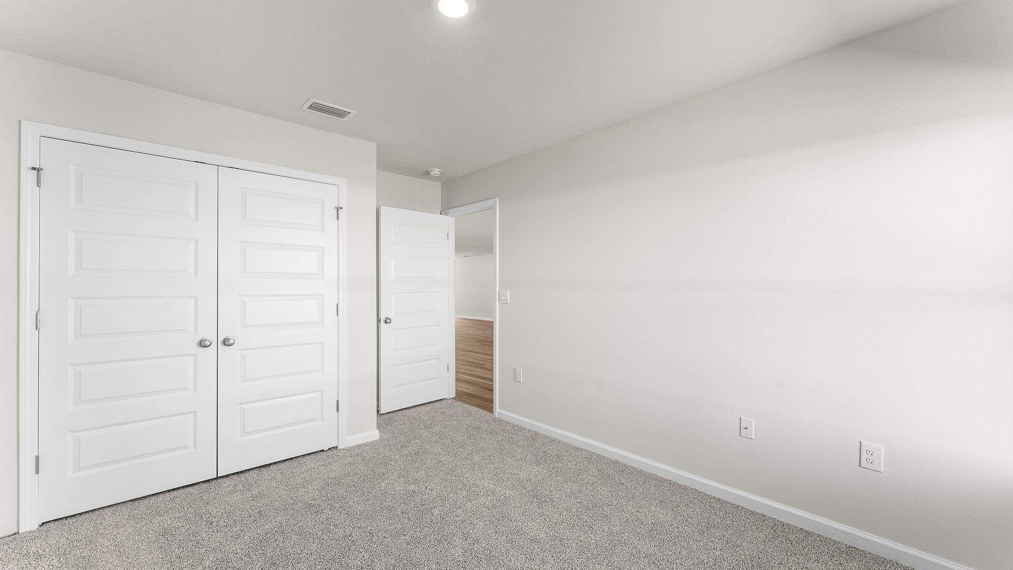Bedroom with carpet floors and closet.