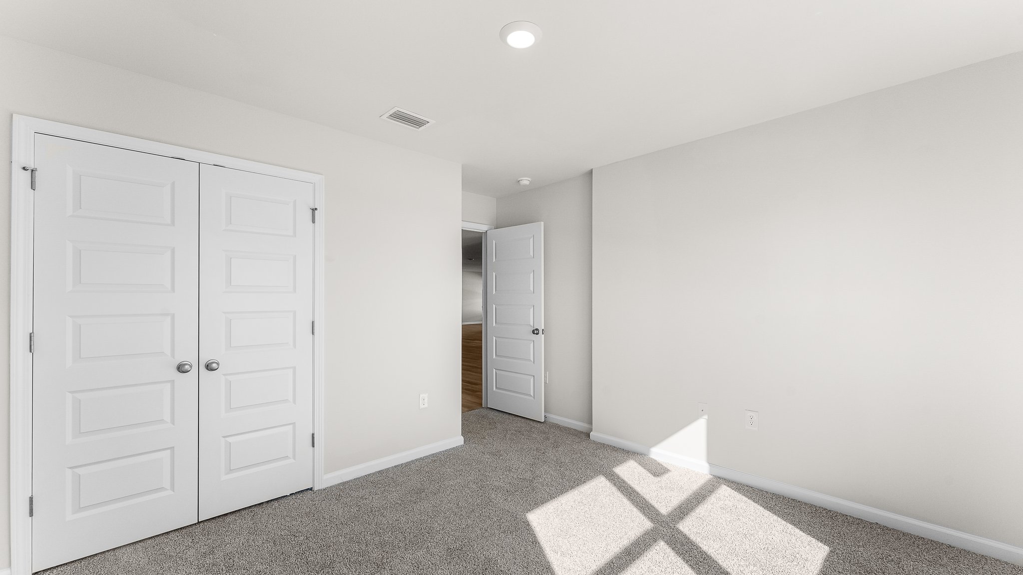 Bedroom with carpet floors and closet.