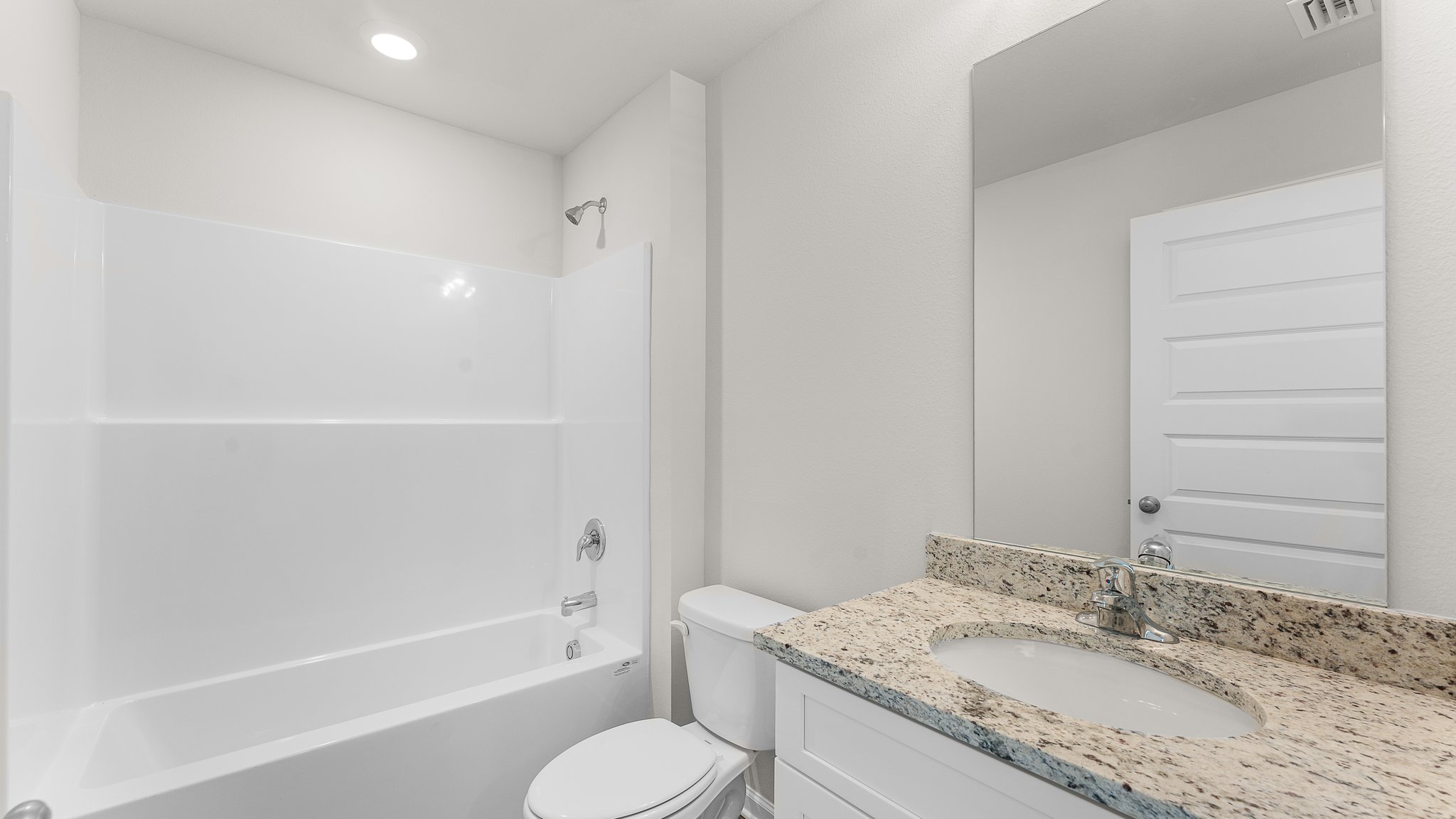 Bathroom with EVP flooring and white cabinets with granite countertop and single vanity and shower and toilet.